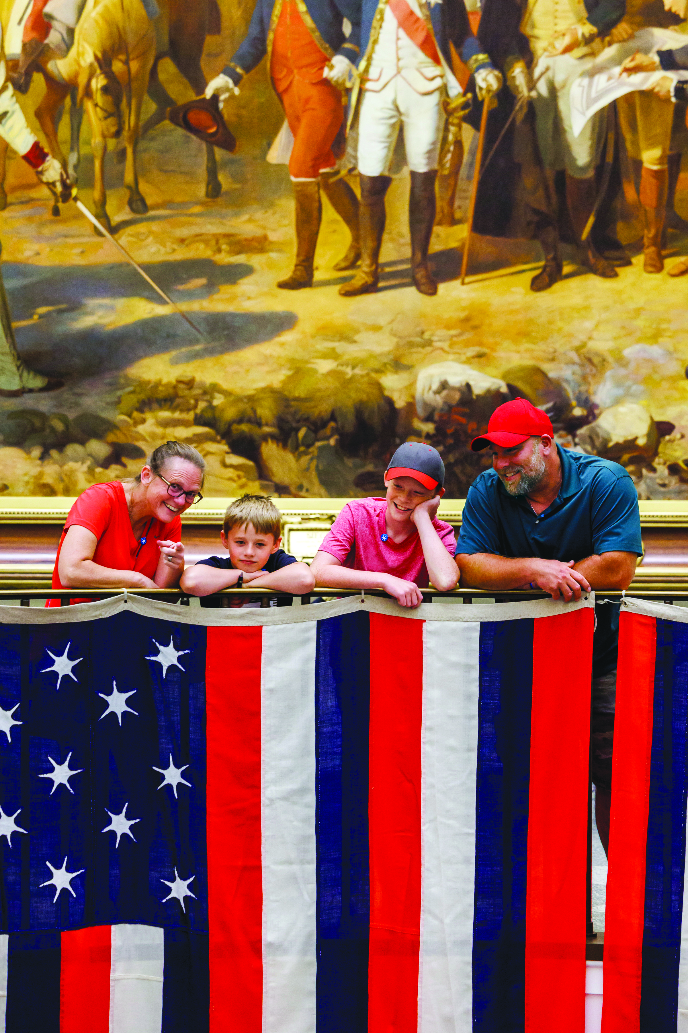 True Colours Flags with family of four looking over railing.