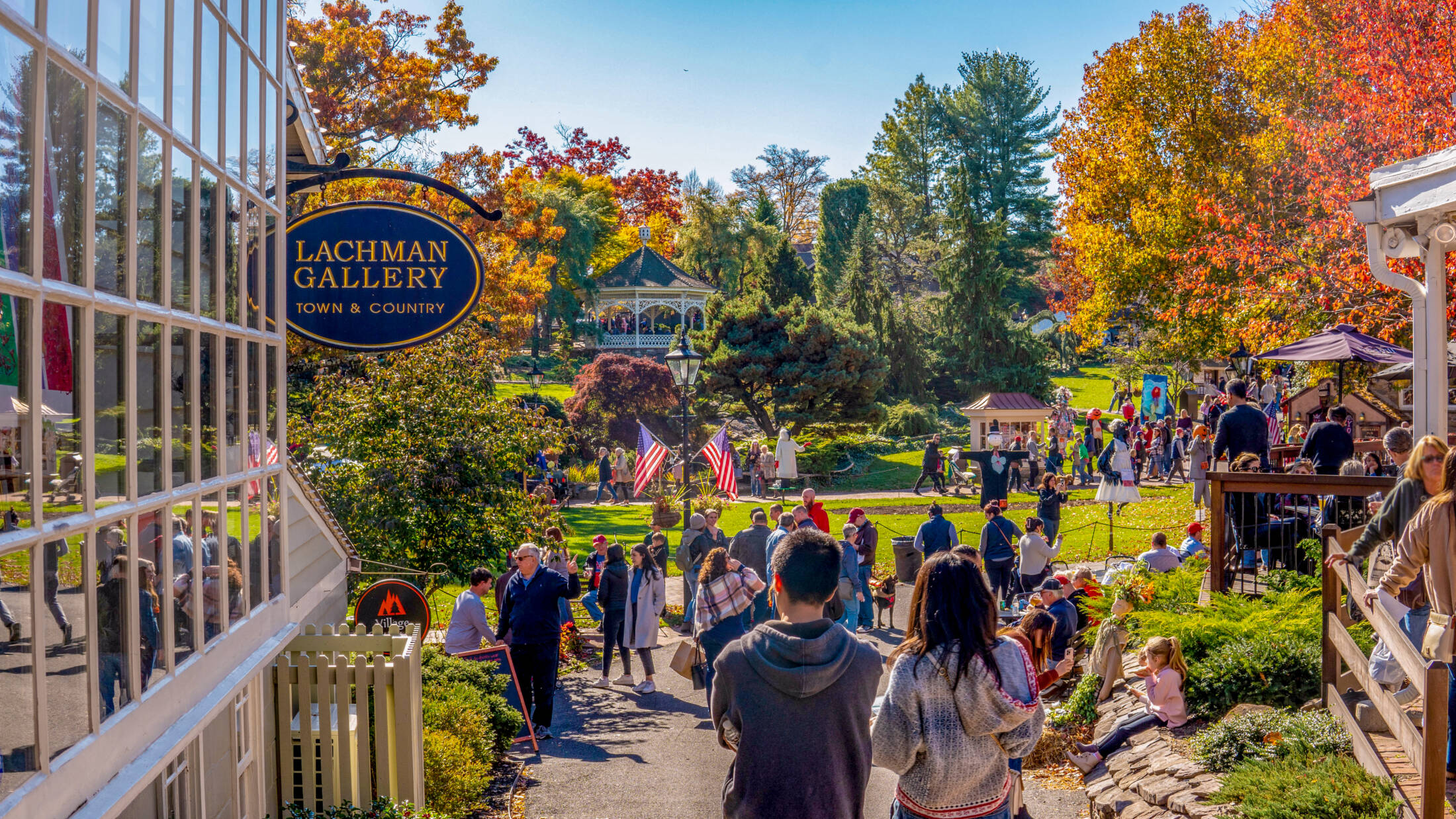 This image shows visitors walking past shop fronts at Peddler's Village.