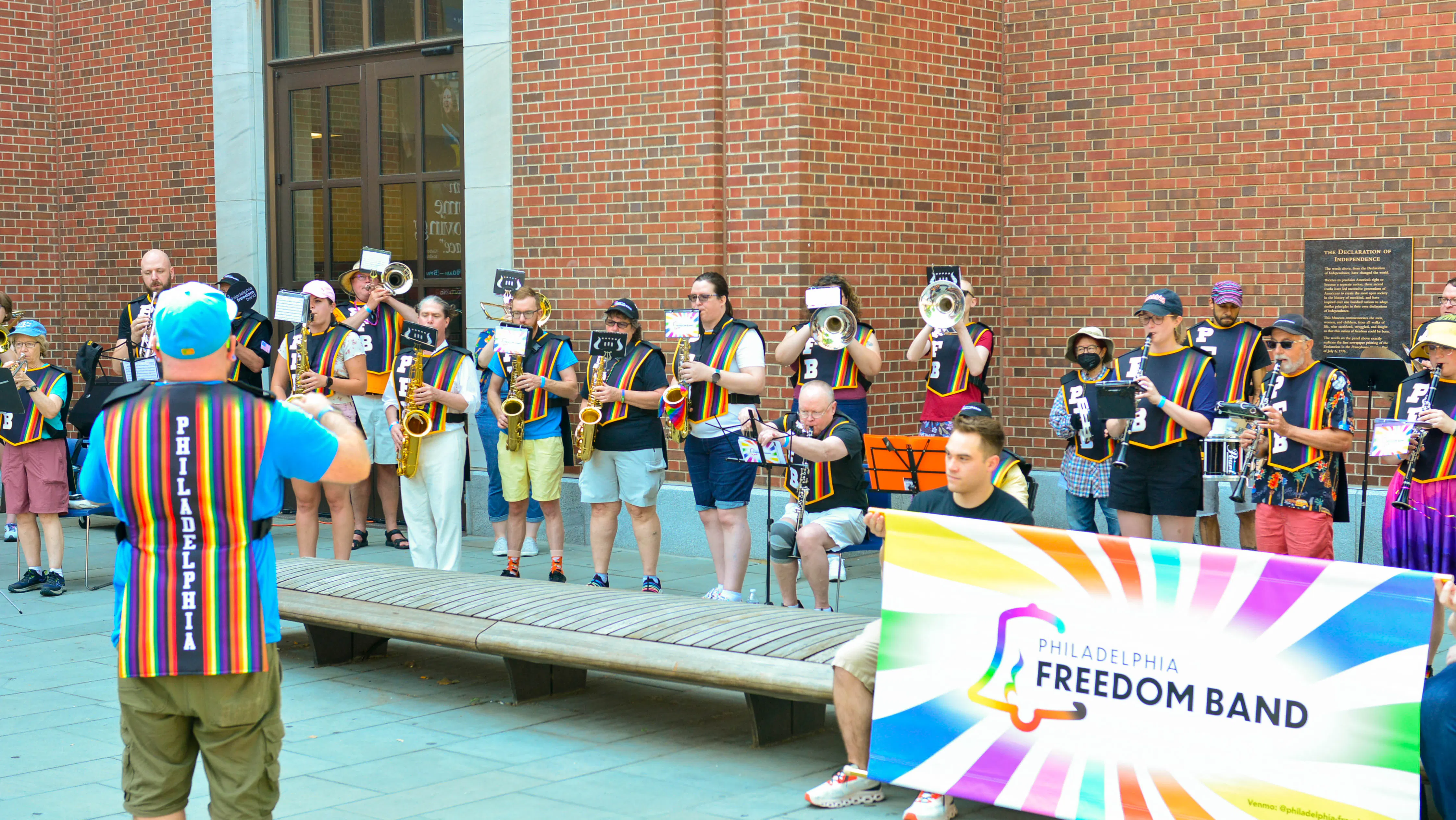 Philadelpha Freedom Band holding rainbow sign