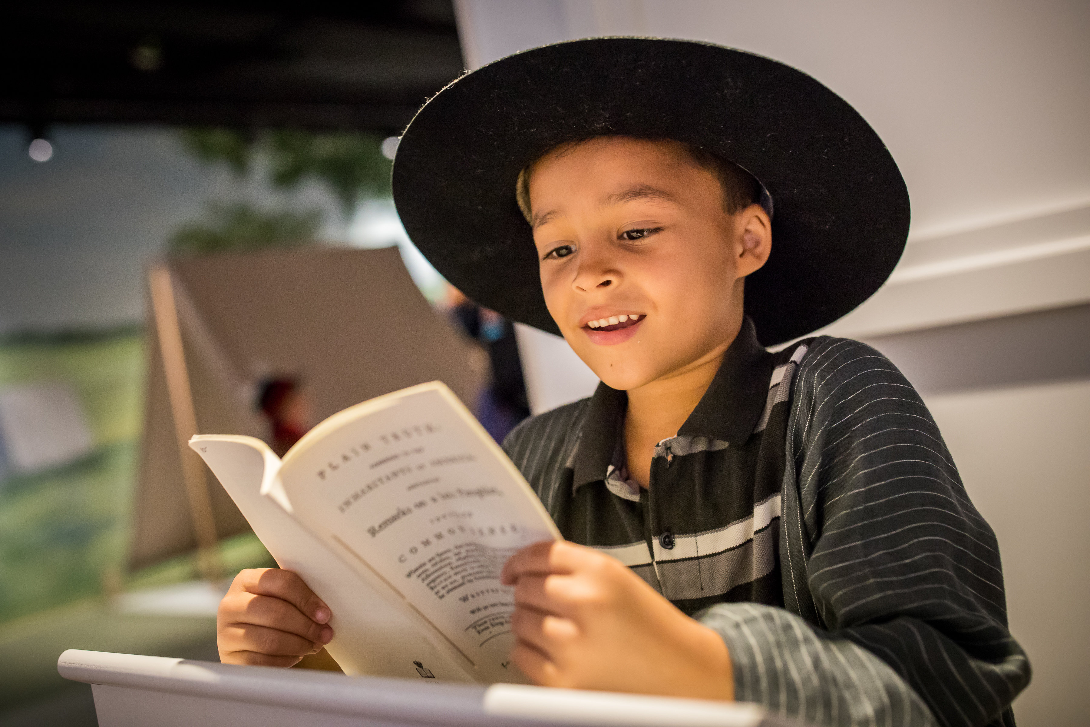 A male adolescent reads in Revolution Place.