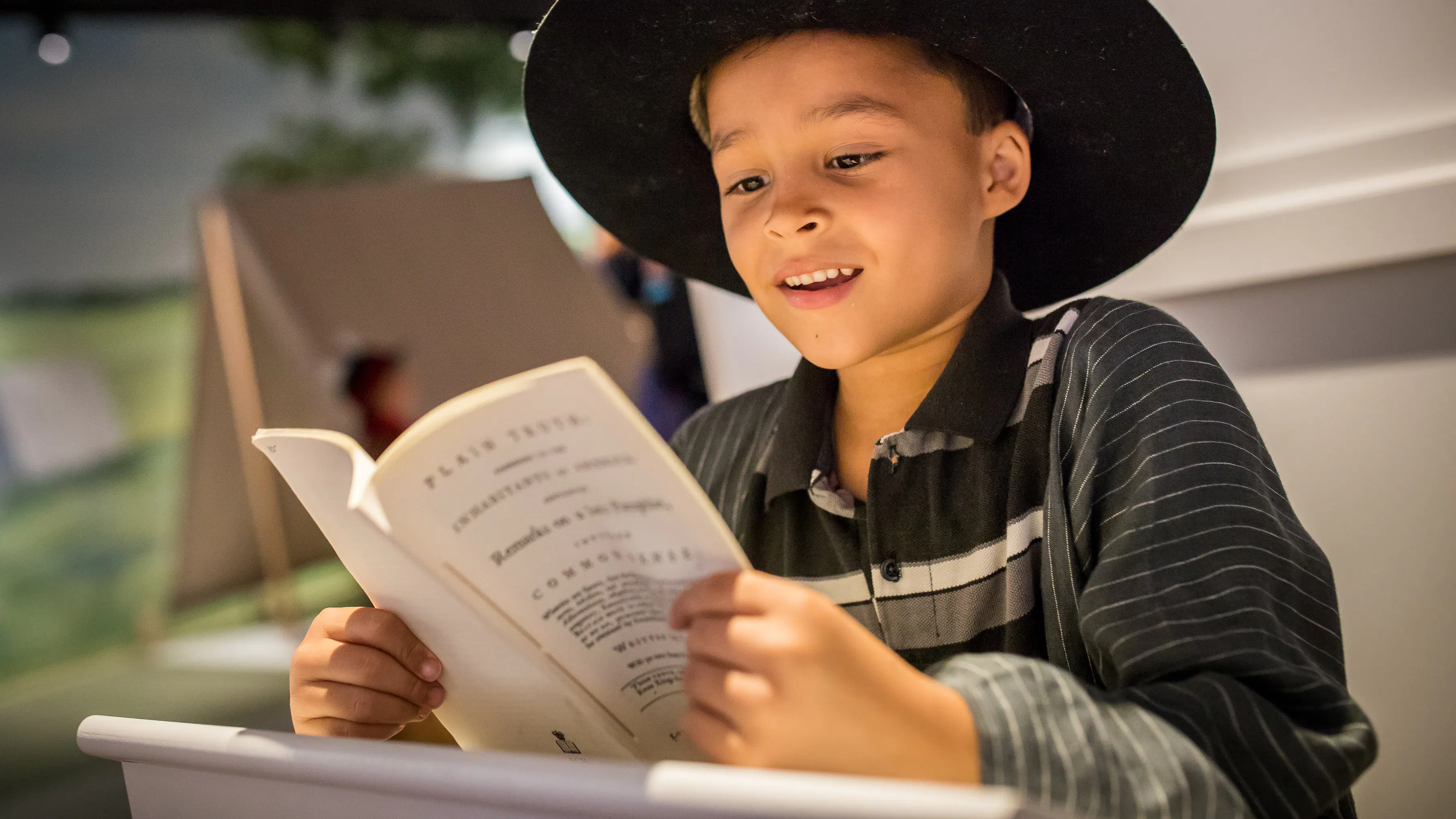 A male adolescent reads in Revolution Place.