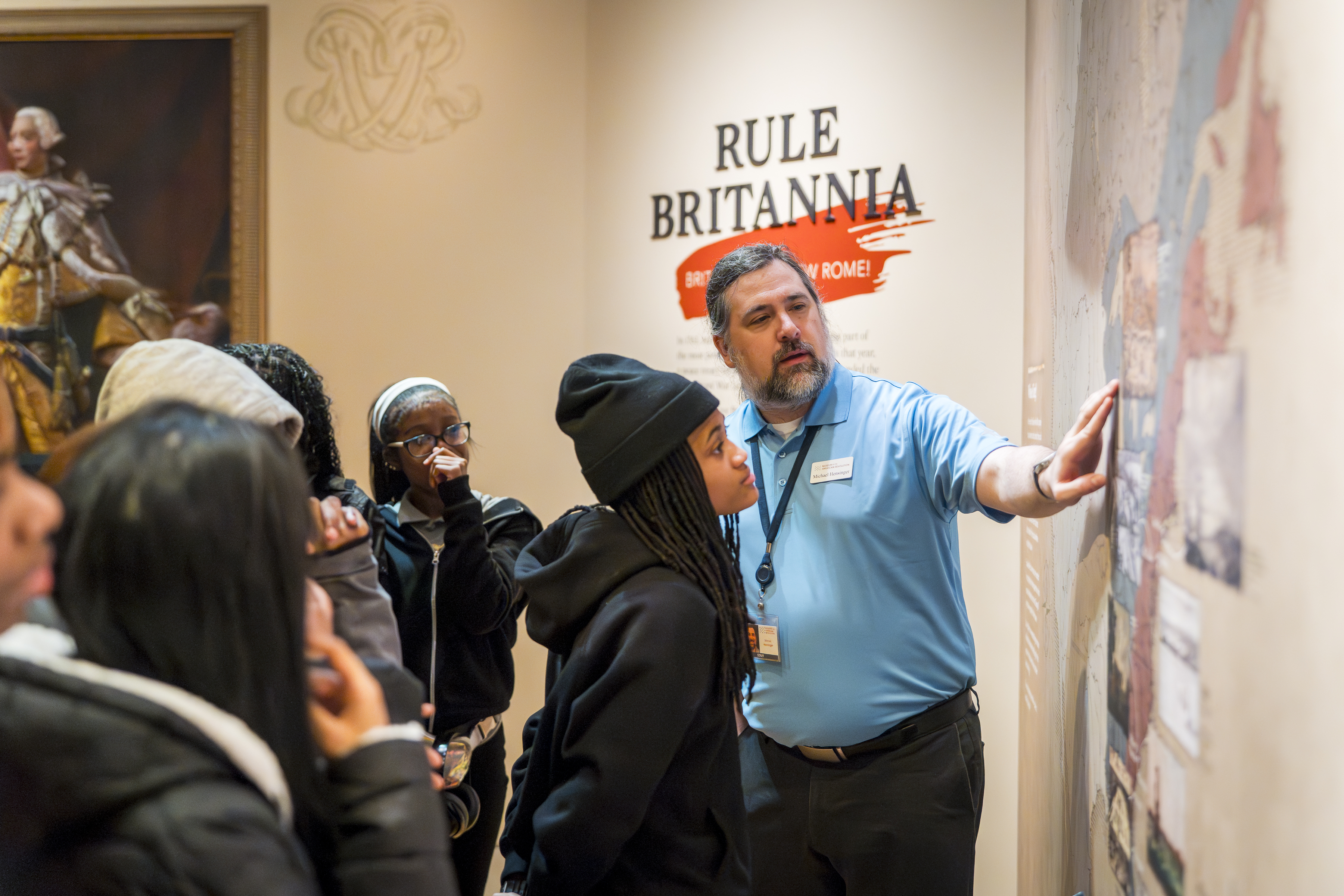 A Museum educator speaks to students