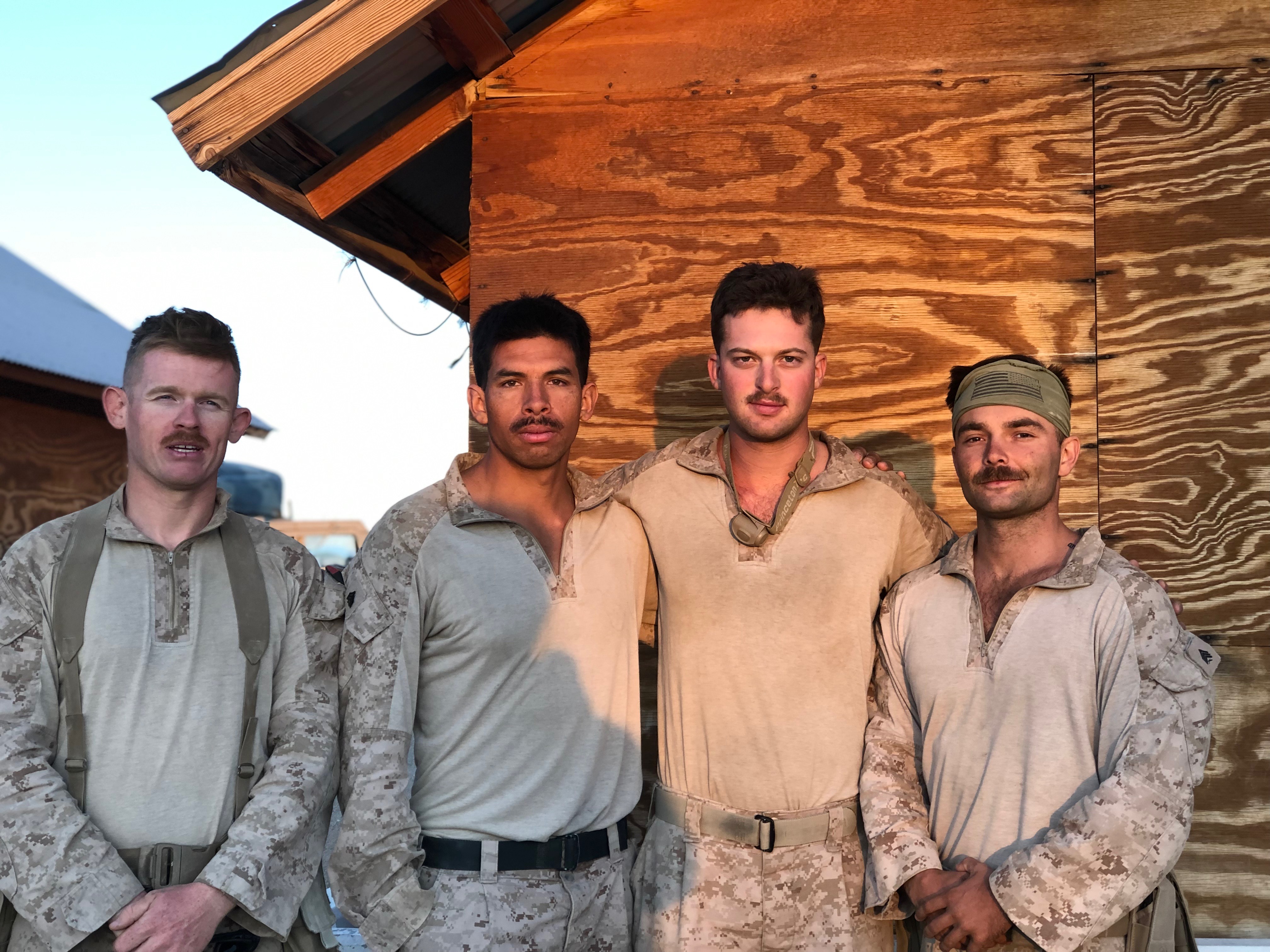 Photo of Adam Straus, third from left, with three other veterans that he served with.