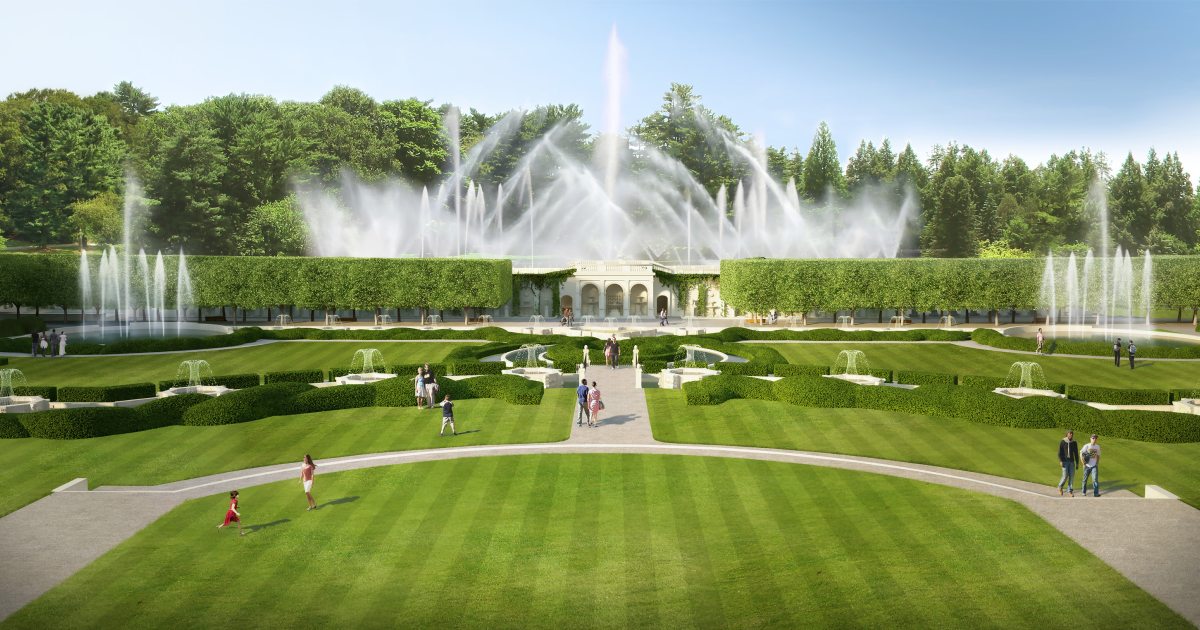 This image shows a large water fountain across a green field at Longwood Gardens.