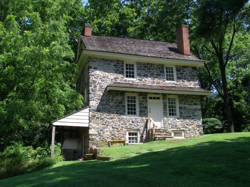 This image shows a modest old stone house that was owned by John Chads in the 18th century.