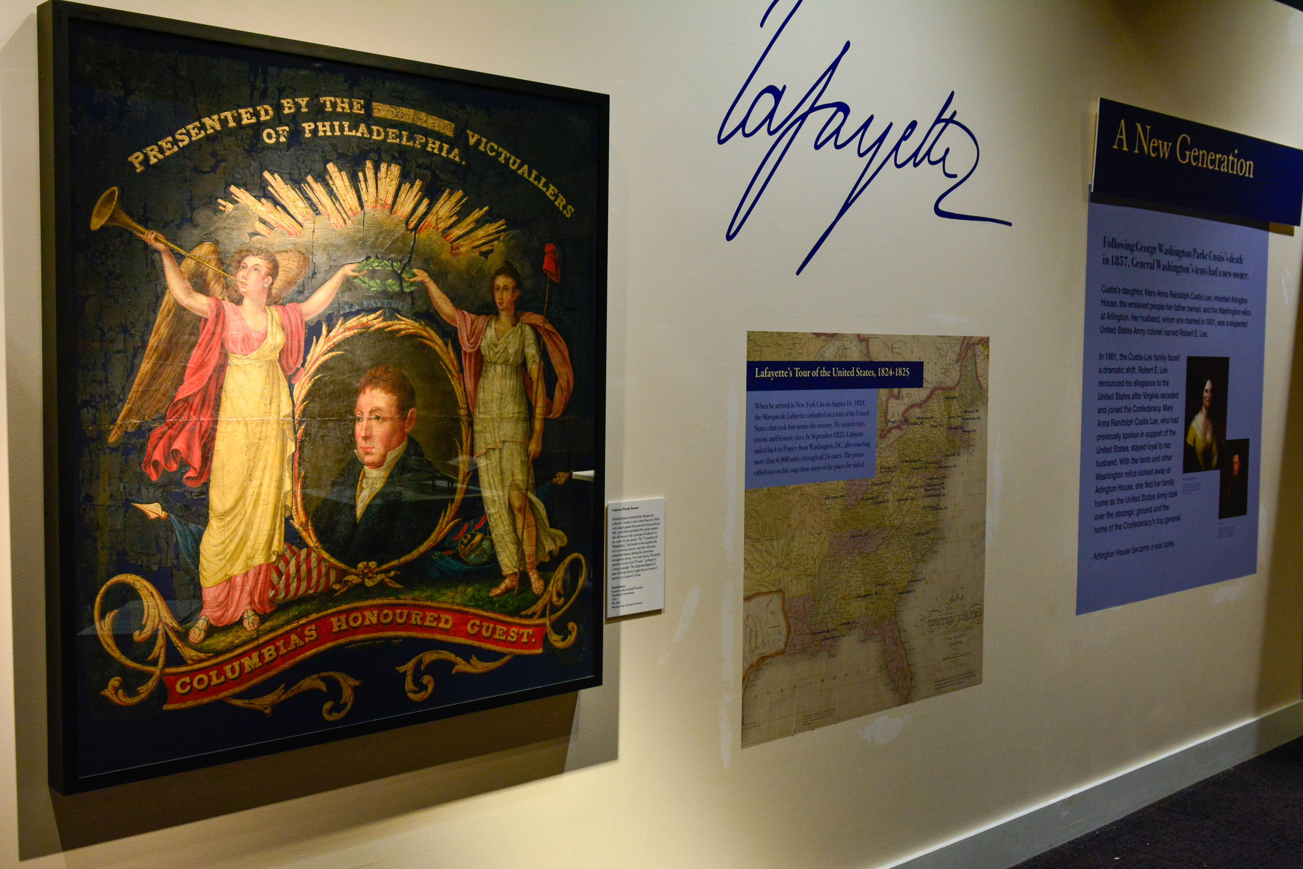 A painted silk parade banner featuring a portrait of the Marquis de Lafayette displayed in the Witness to Revolution exhibit.