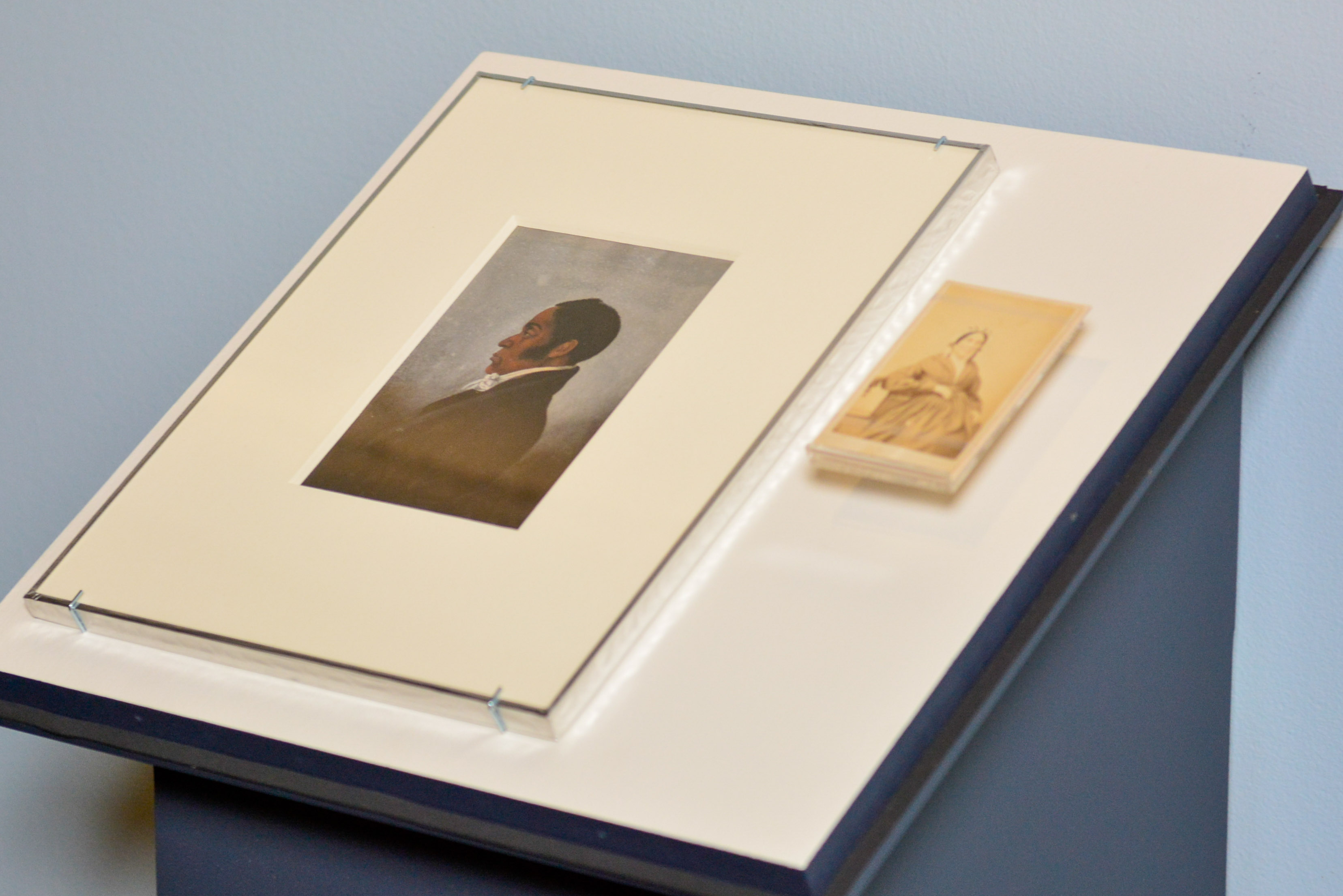 A painted portrait of James Forten is installed next to a small photograph of his wife Charlotte Vandine Forten in the Museum's Black Founders exhibit.