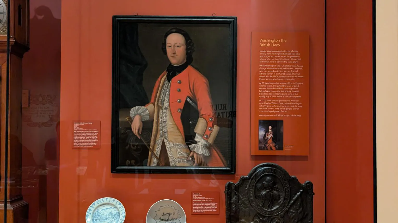 A Museum display case featuring a portrait of a man wearing a military uniform