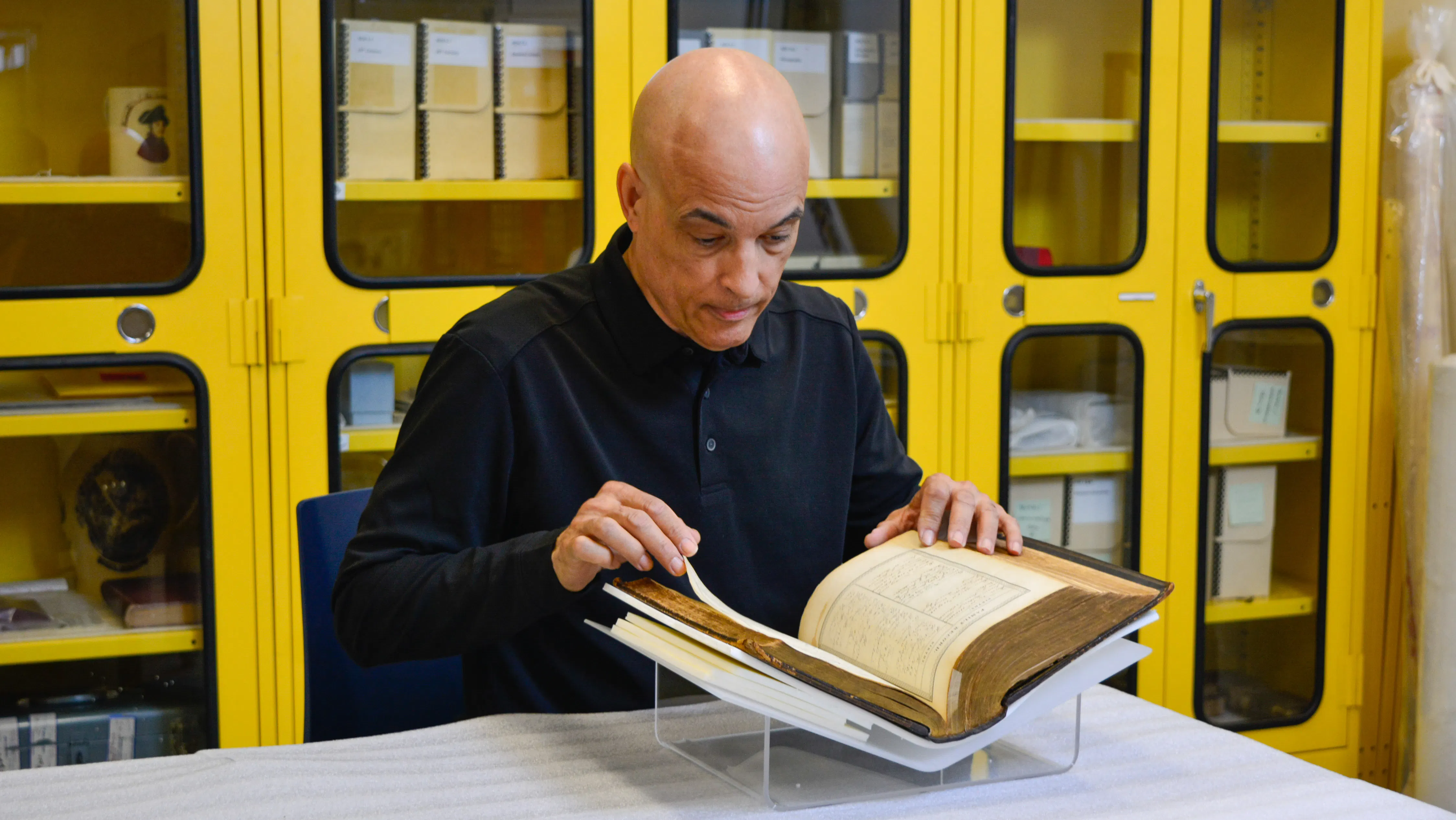 James Forten descendent Kip Forten Jacobs looks at the Forten family Bible, passed down for generations, in the Museum's collections workroom.