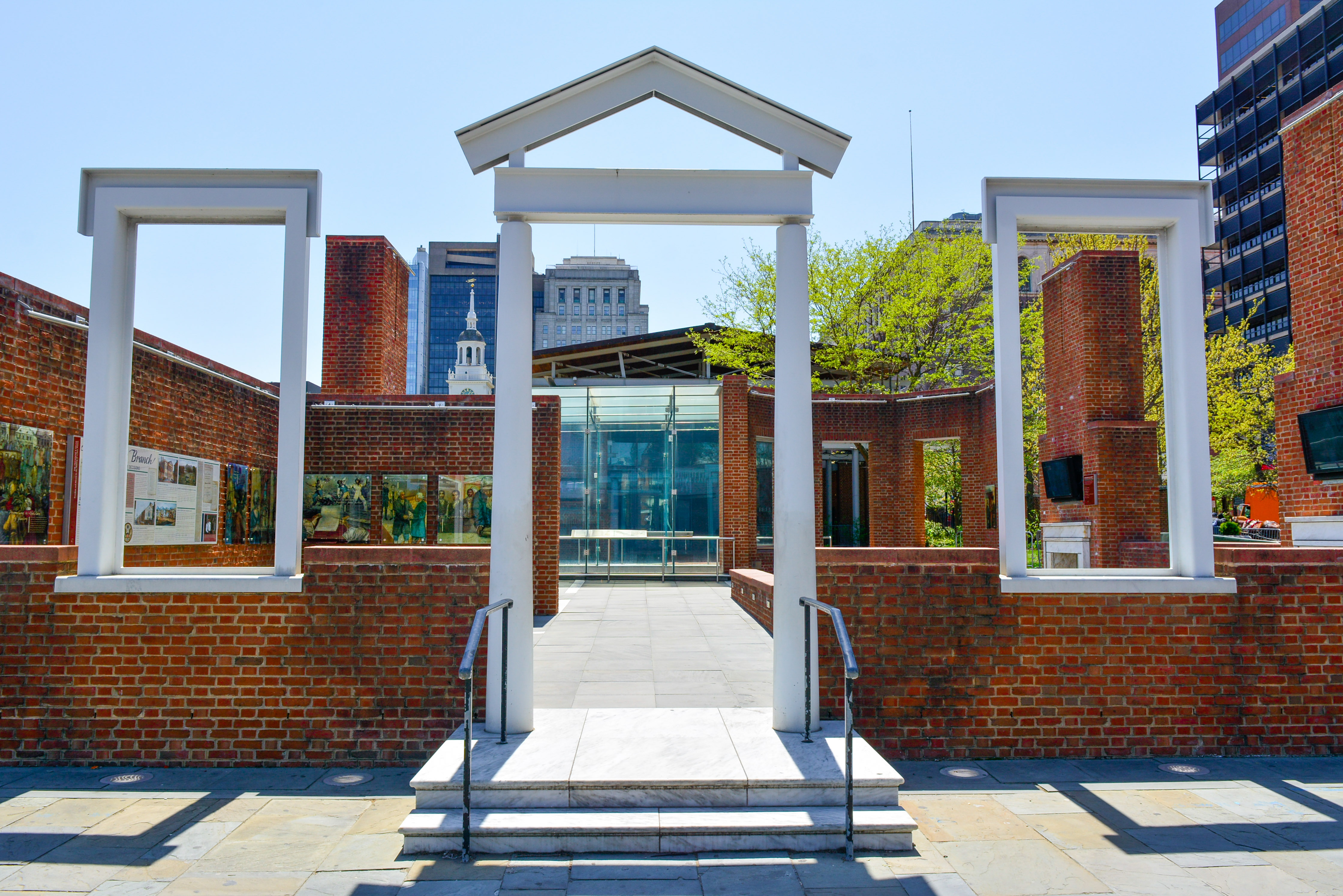 A partial brick structure and outlines of two windows and a door at the site where the President's House once stood on Market Street in Philadelphia.