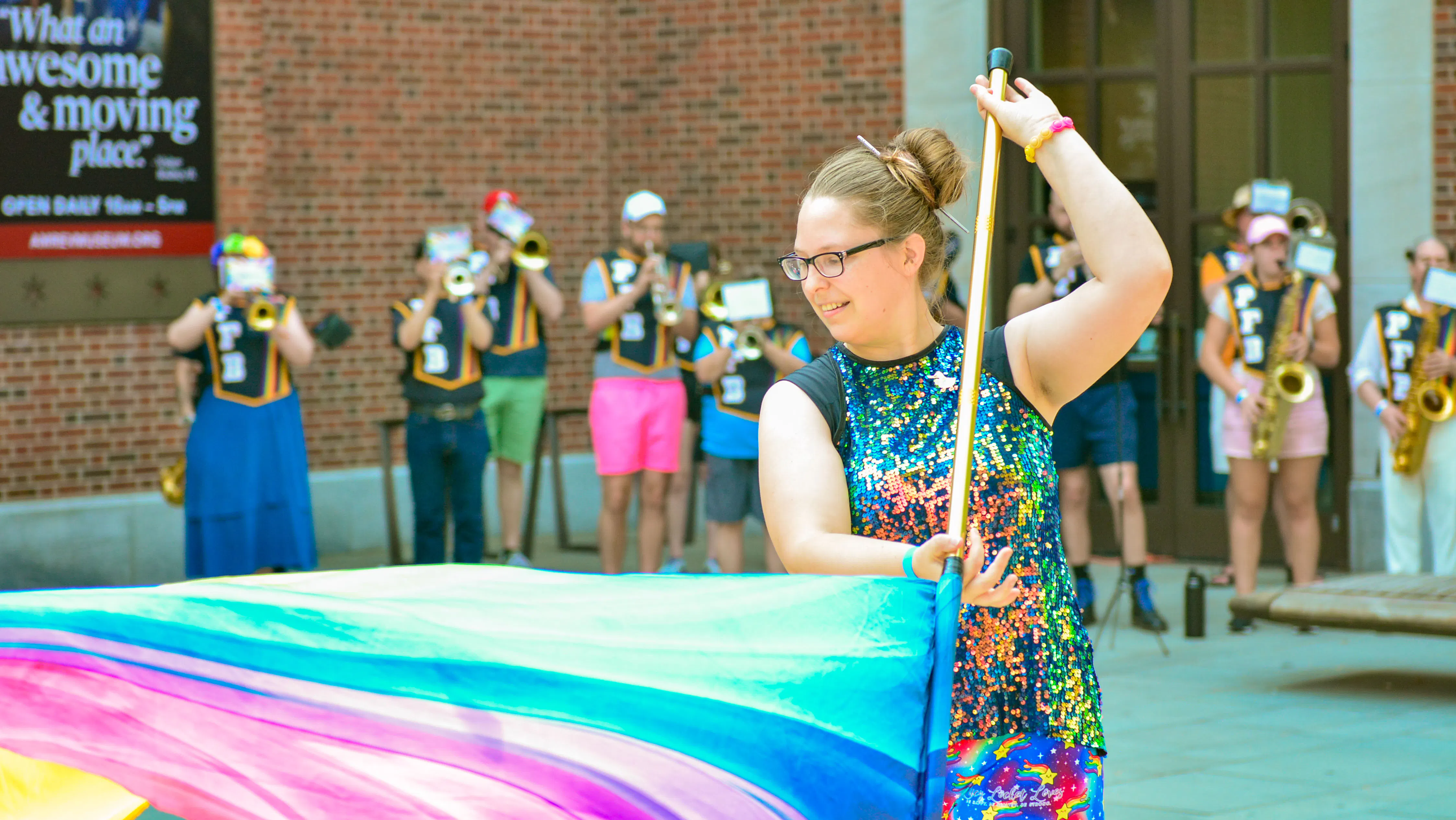 Philadelhia Freedom Band color guard member twirling rainbow flag