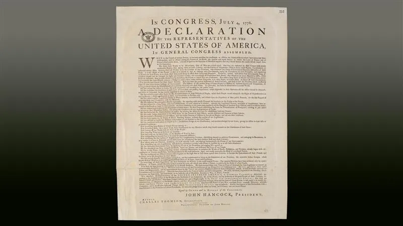 A printing of the Declaration of Independence on a gradient gray-to-black background.