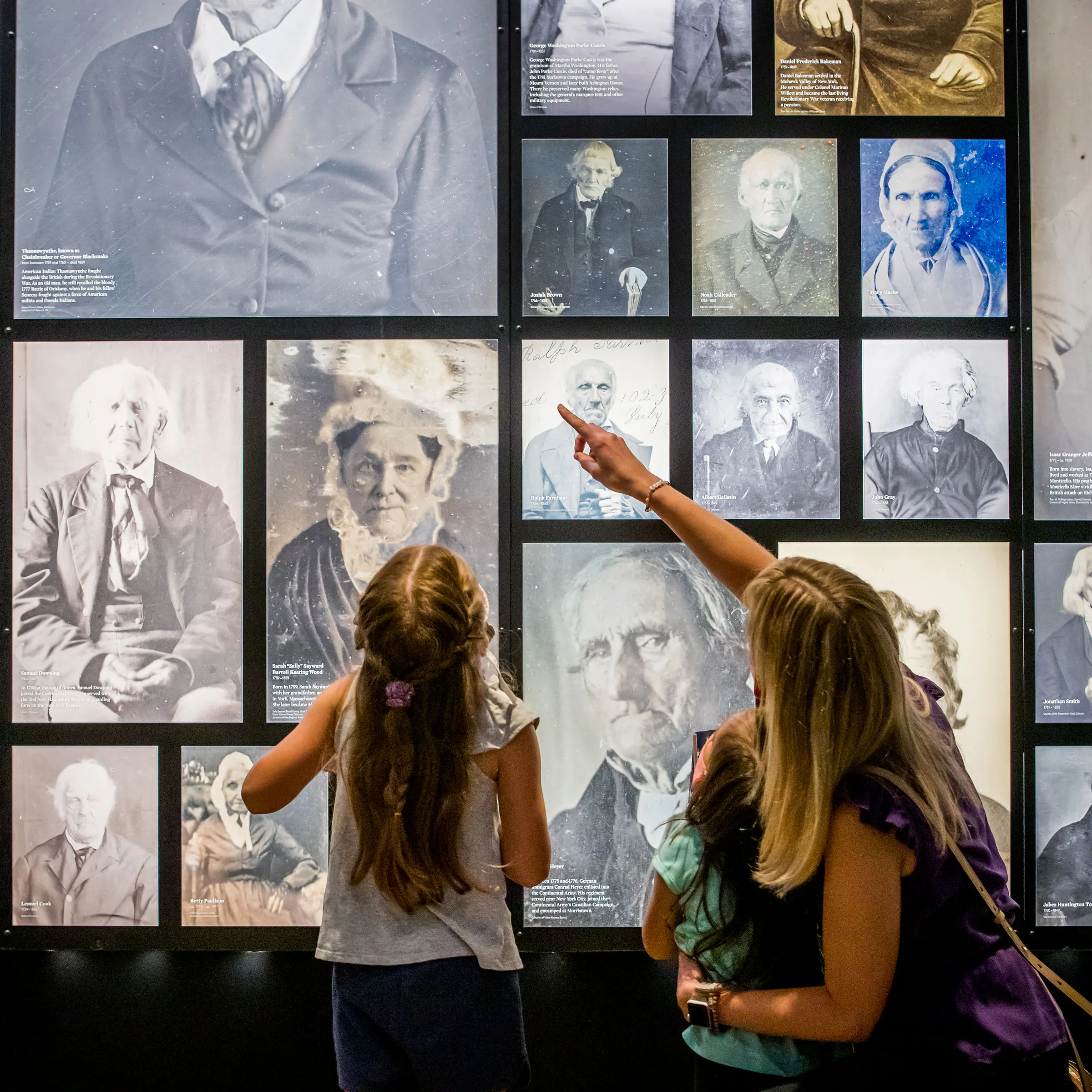 Guests with masks enjoy the images of Revolutionary War veterans.