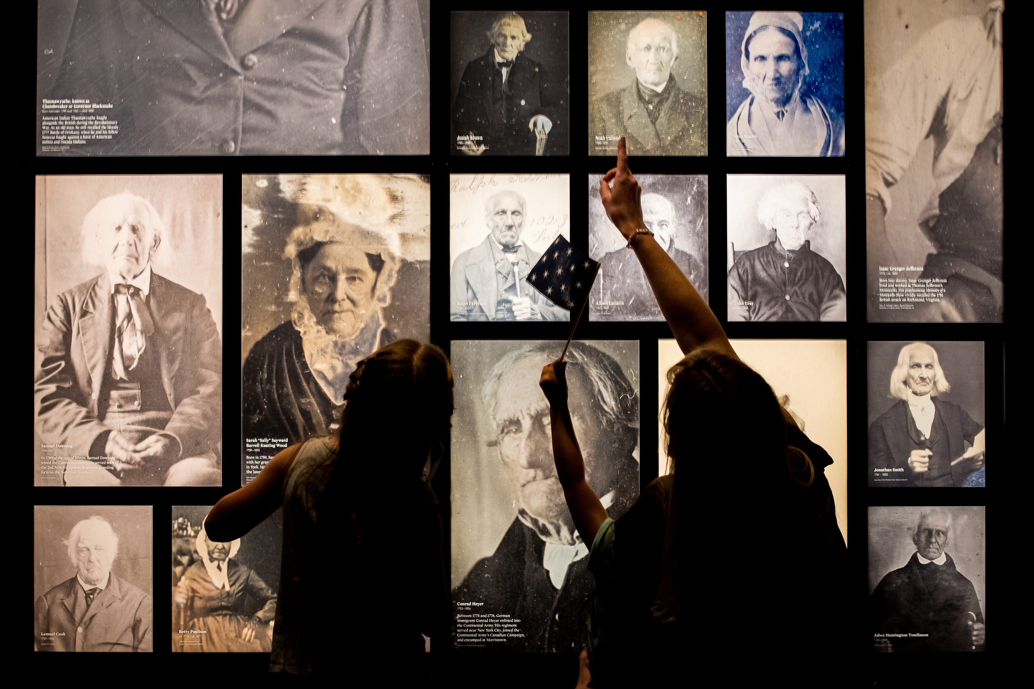 Guests with masks enjoy the images of Revolutionary War veterans.