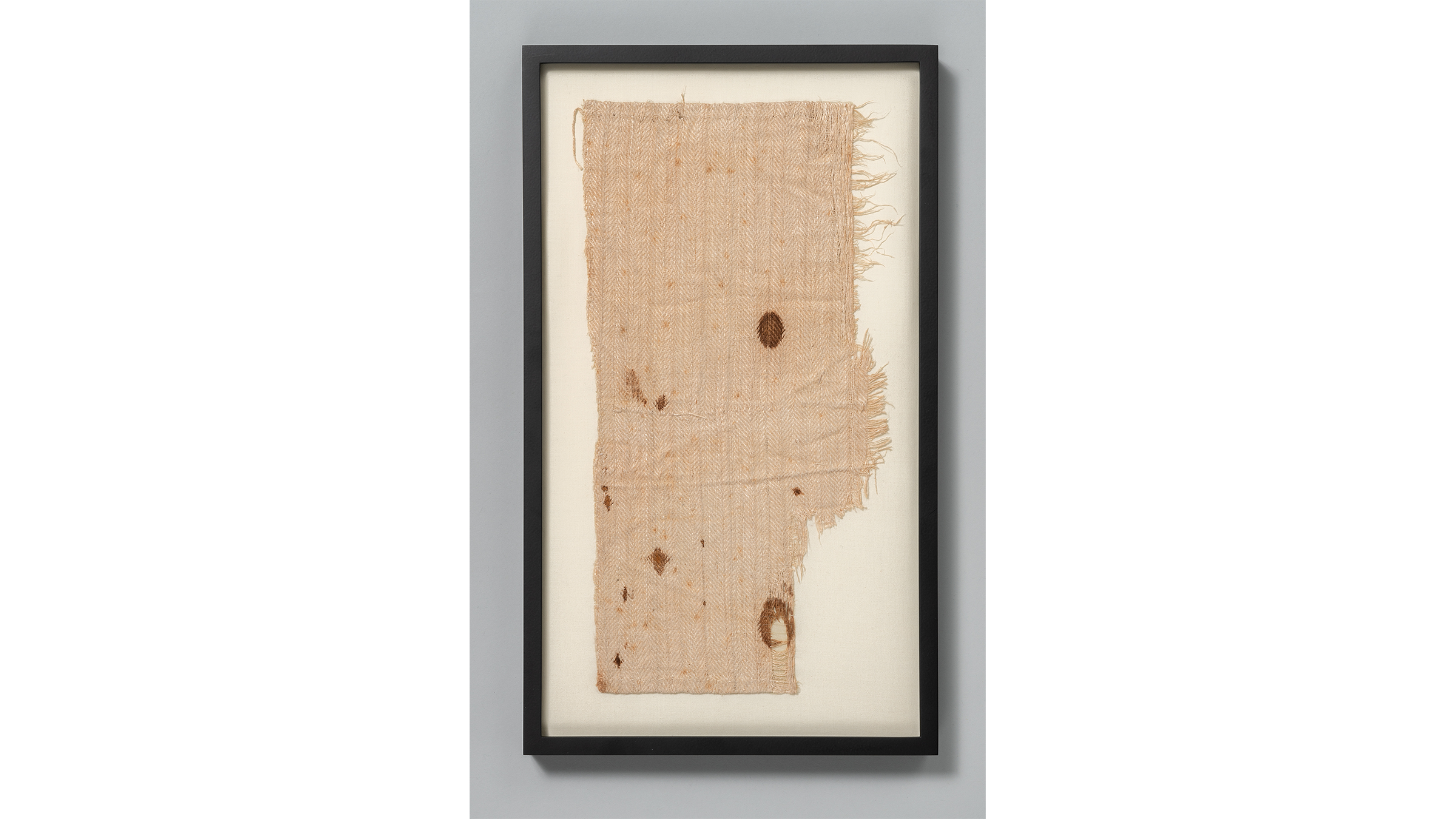A browning aging fragment of linen fabric cut from the inner chamber of George Washington's wartime tent.