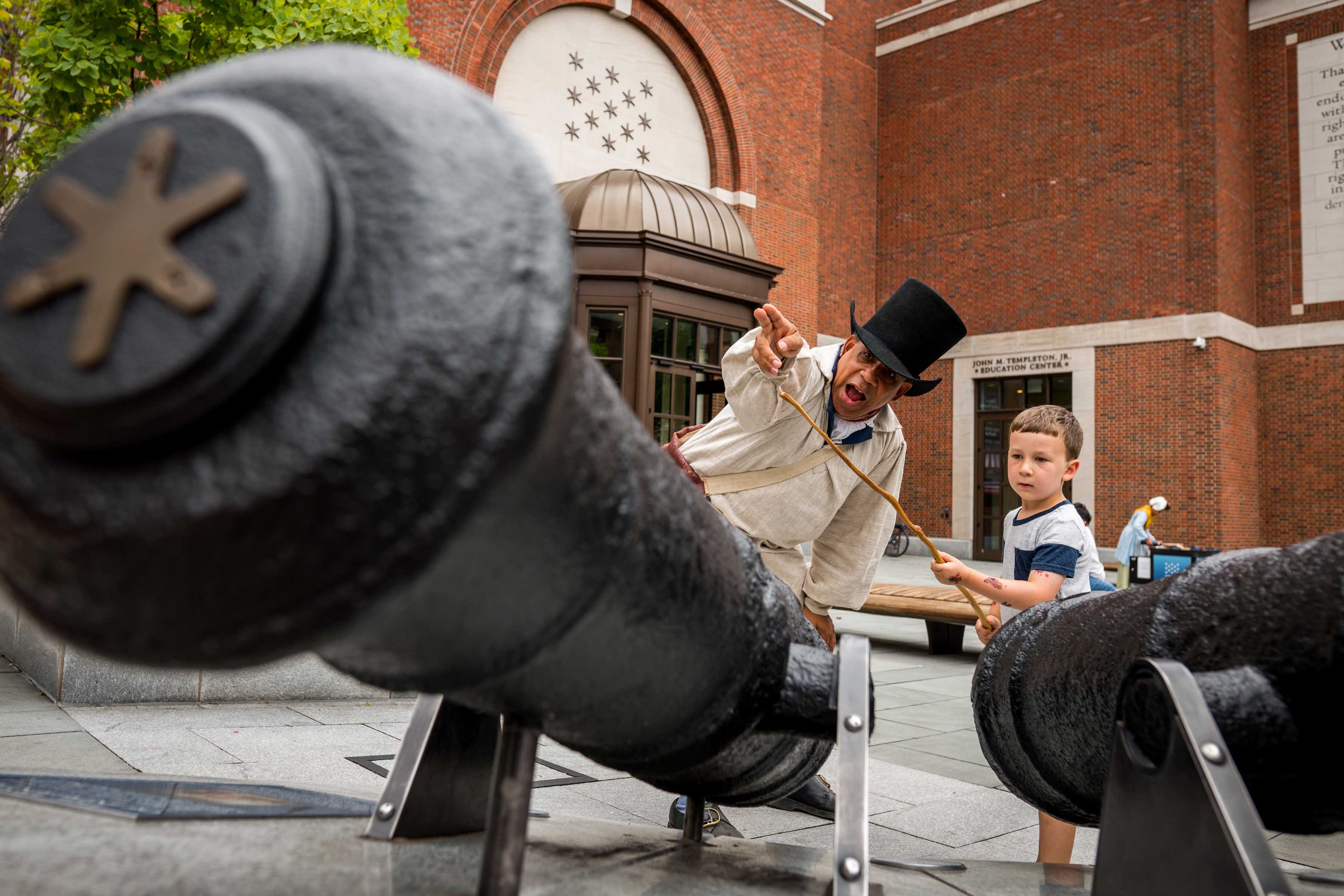 Noah Lewis portrays Ned Hector and teaches a young guest how to fire a cannon as part of our Meet The Revolution series.