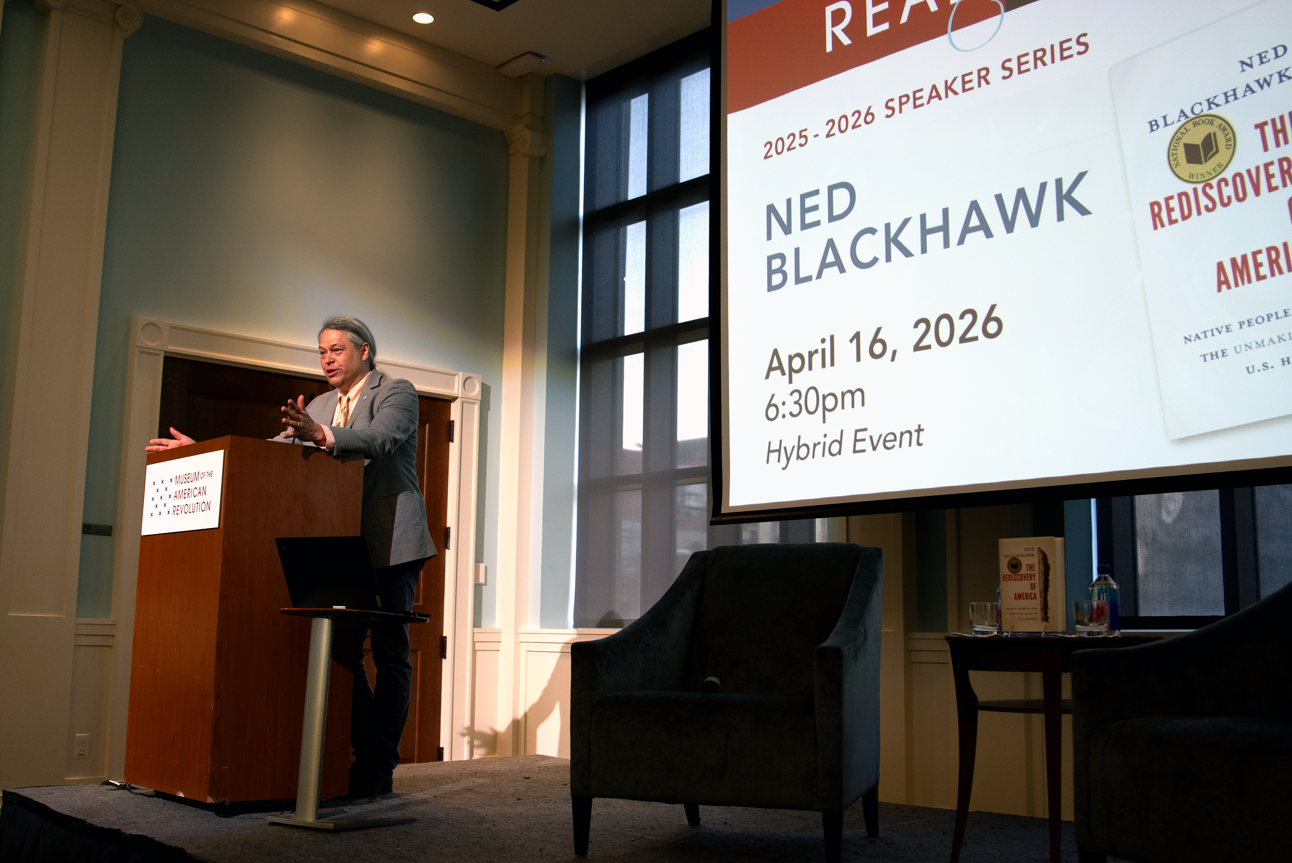 Ned Blackhawk stands at a podium