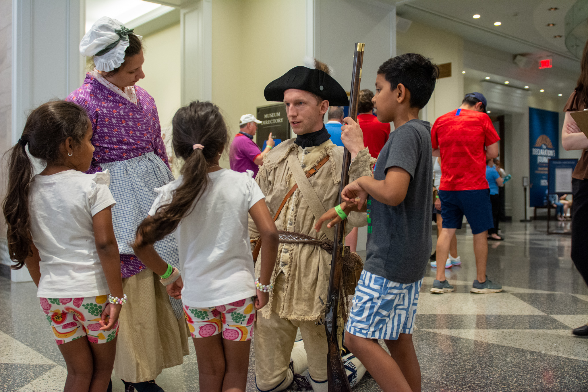 A costumed interpreter interacts with guests