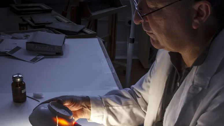 Scientist examining antique ceramic bowl