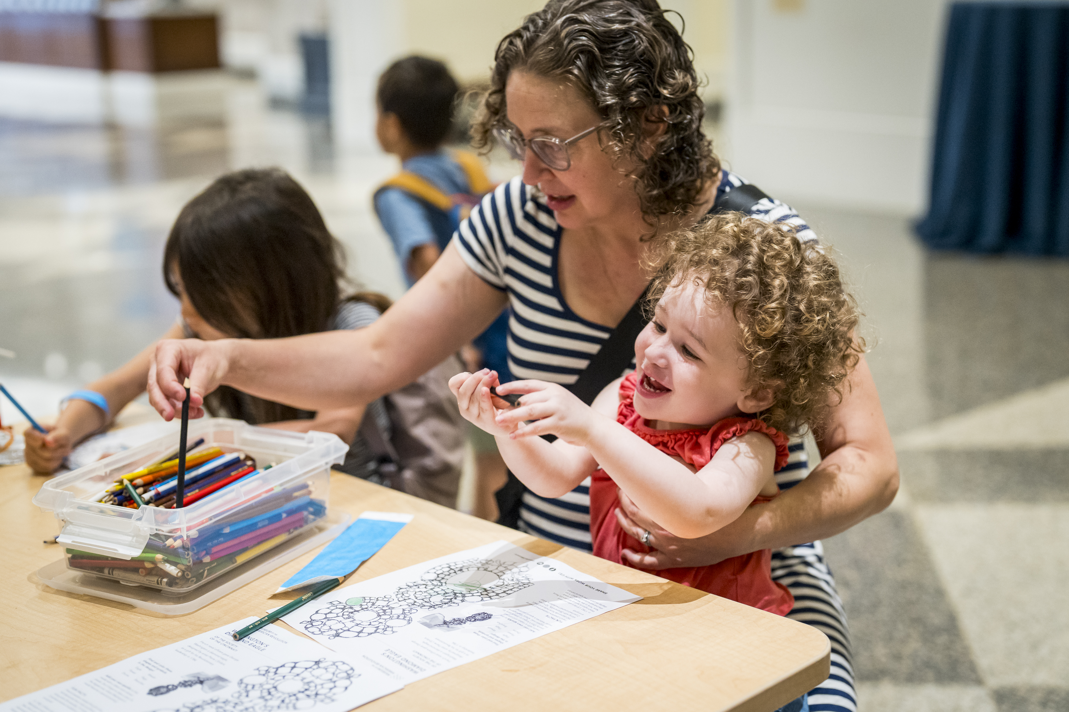 A parent and child do a craft