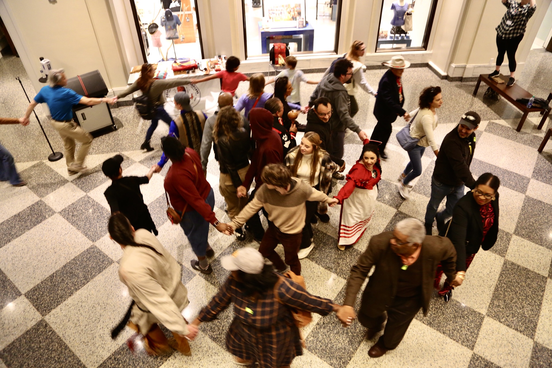 Guests participate in Lenape social dances in the Museum rotunda with representatives from the Delaware Tribe of Indians.