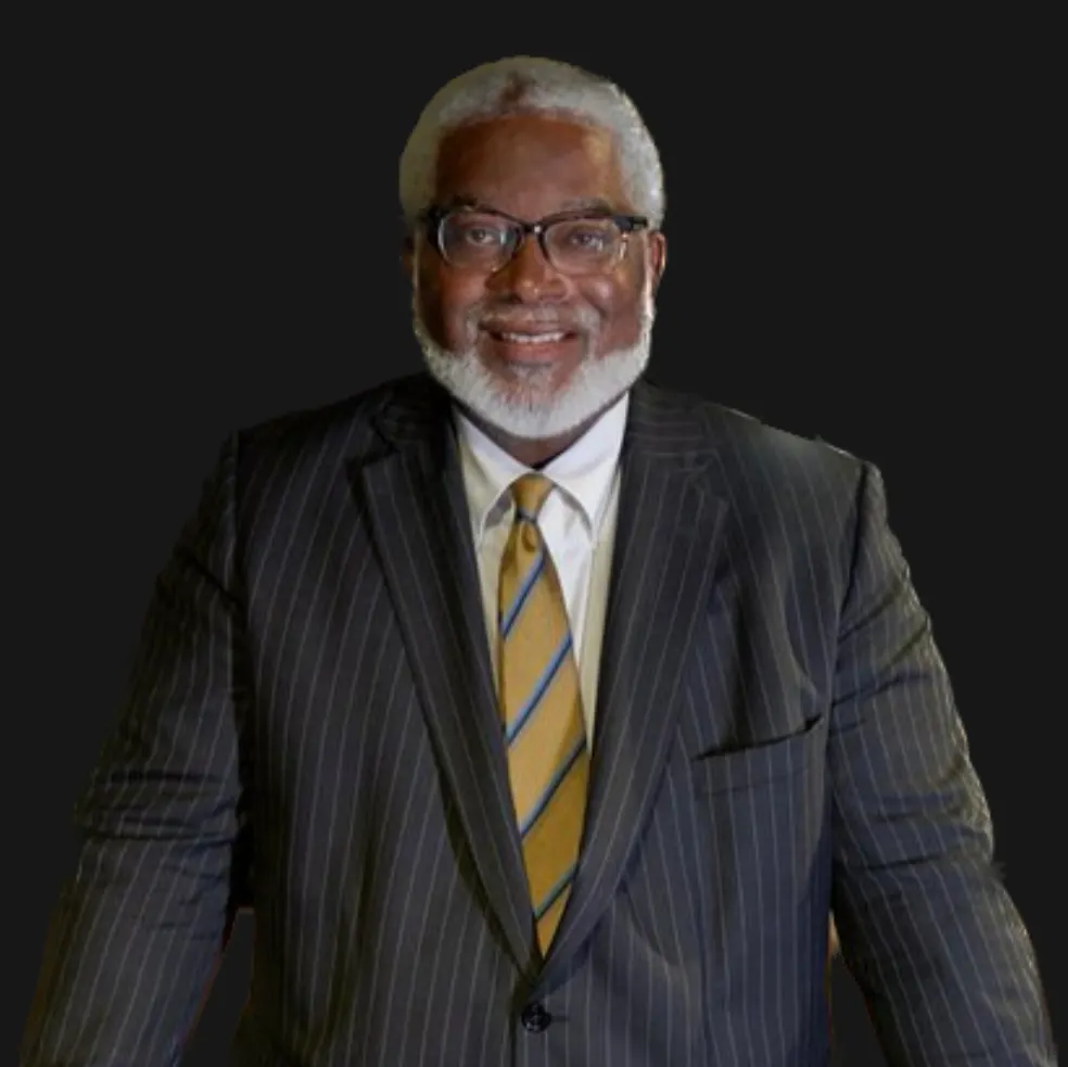 Portrait of Steven Scott Bradley in a dark suit with glasses.