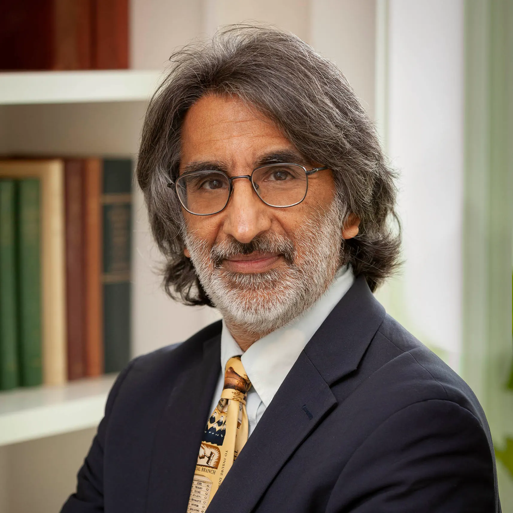 Photo of author and scholar Akhil Reed Amar, who wears glasses, has a gray beard, and salt and pepper long hair.