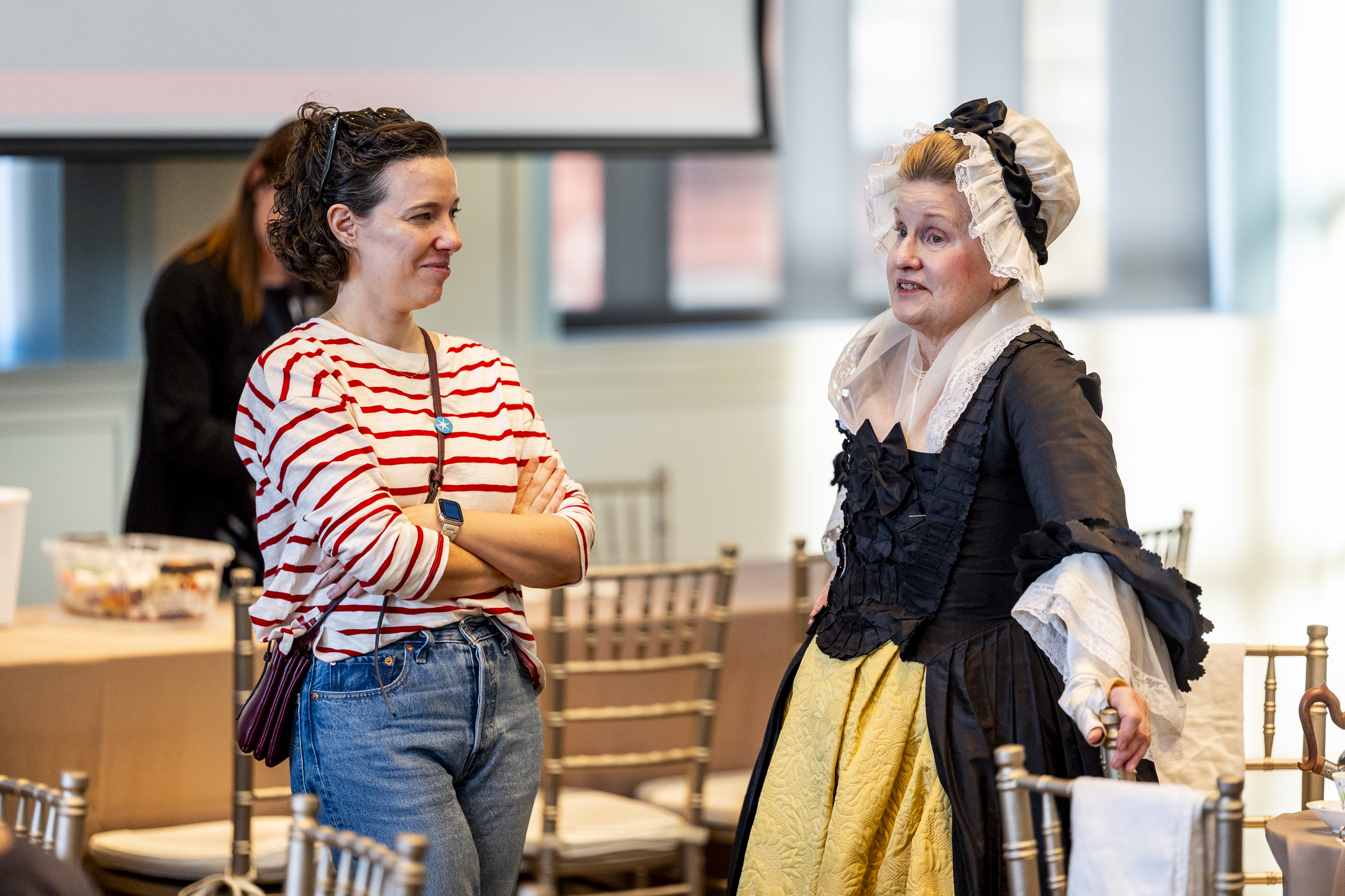 A guest speaks with a costumed interpreter