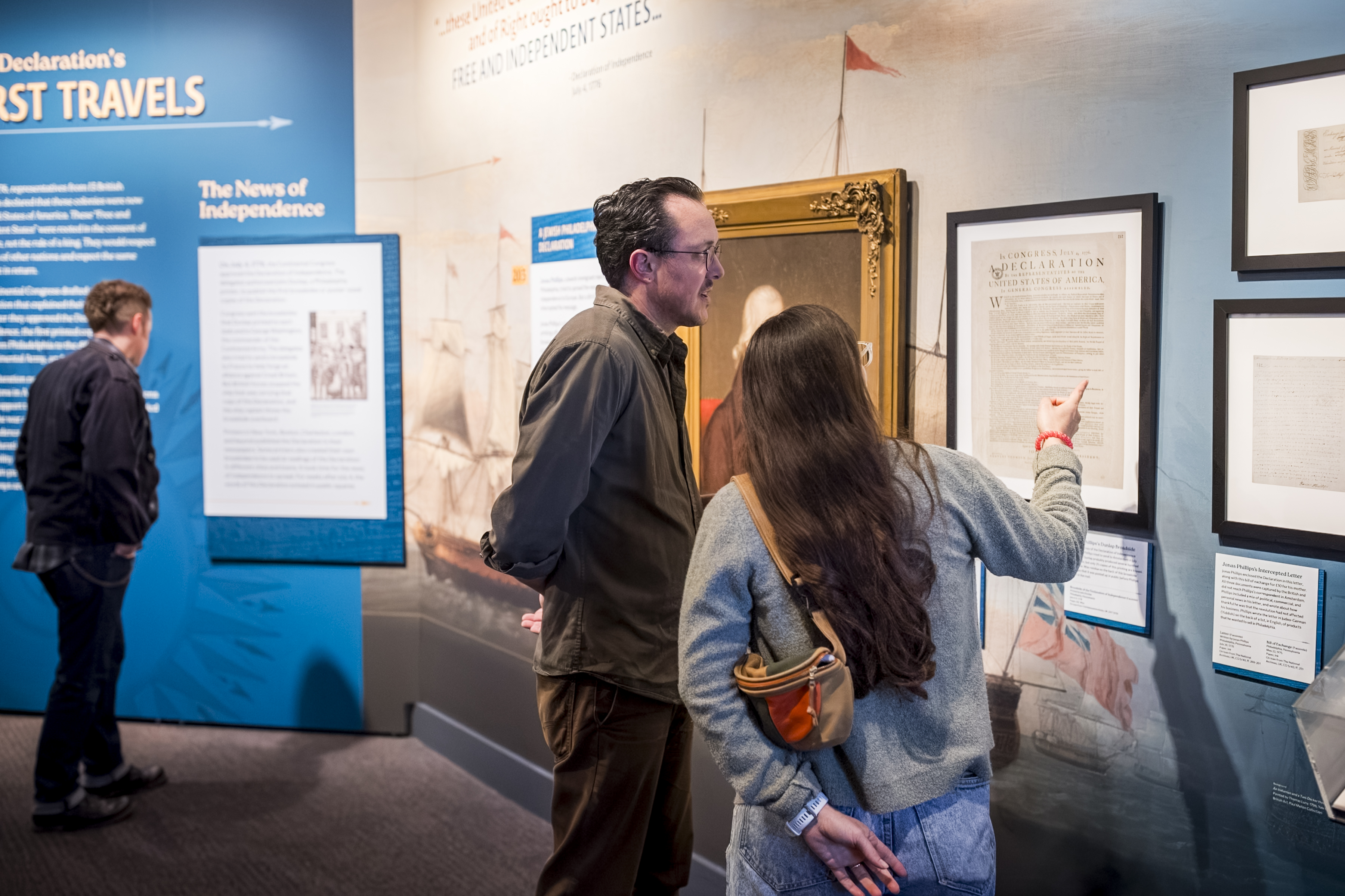 Two people look at a framed document in The Declaration's Journey