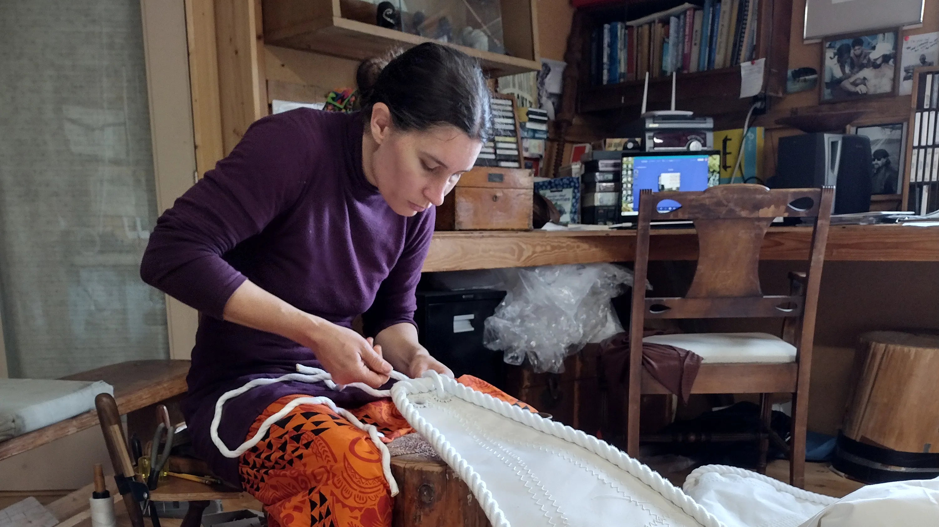 Force10 Sailmaking's Nahja Chimenti works on a sail in the family business's workshop.