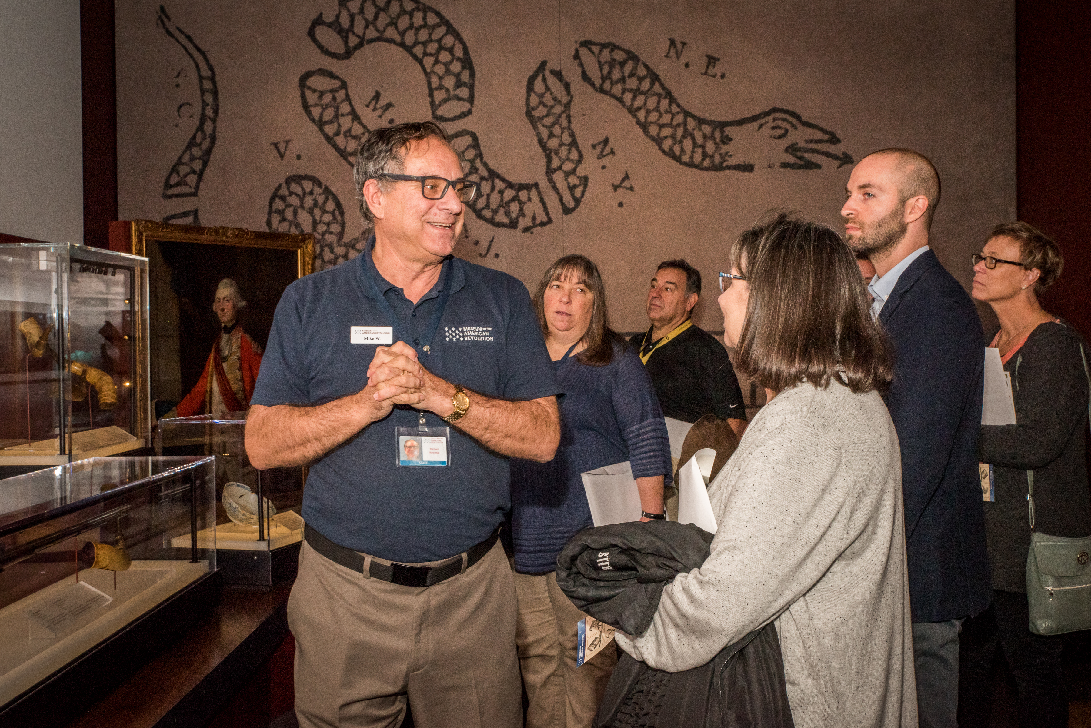 A Museum eductor leads a group of professionals on a tour of the core galleries.