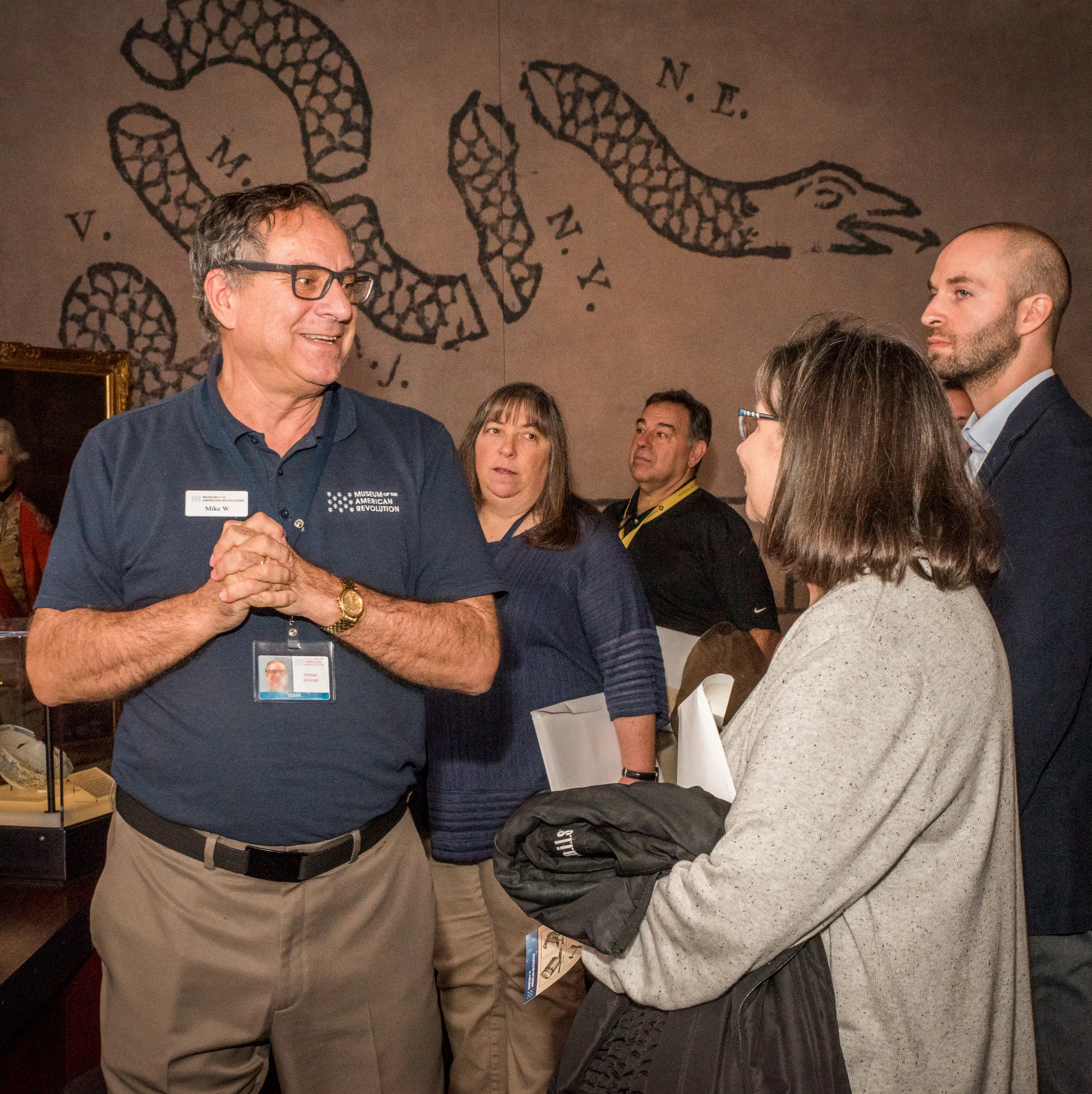 A Museum eductor leads a group of professionals on a tour of the core galleries.