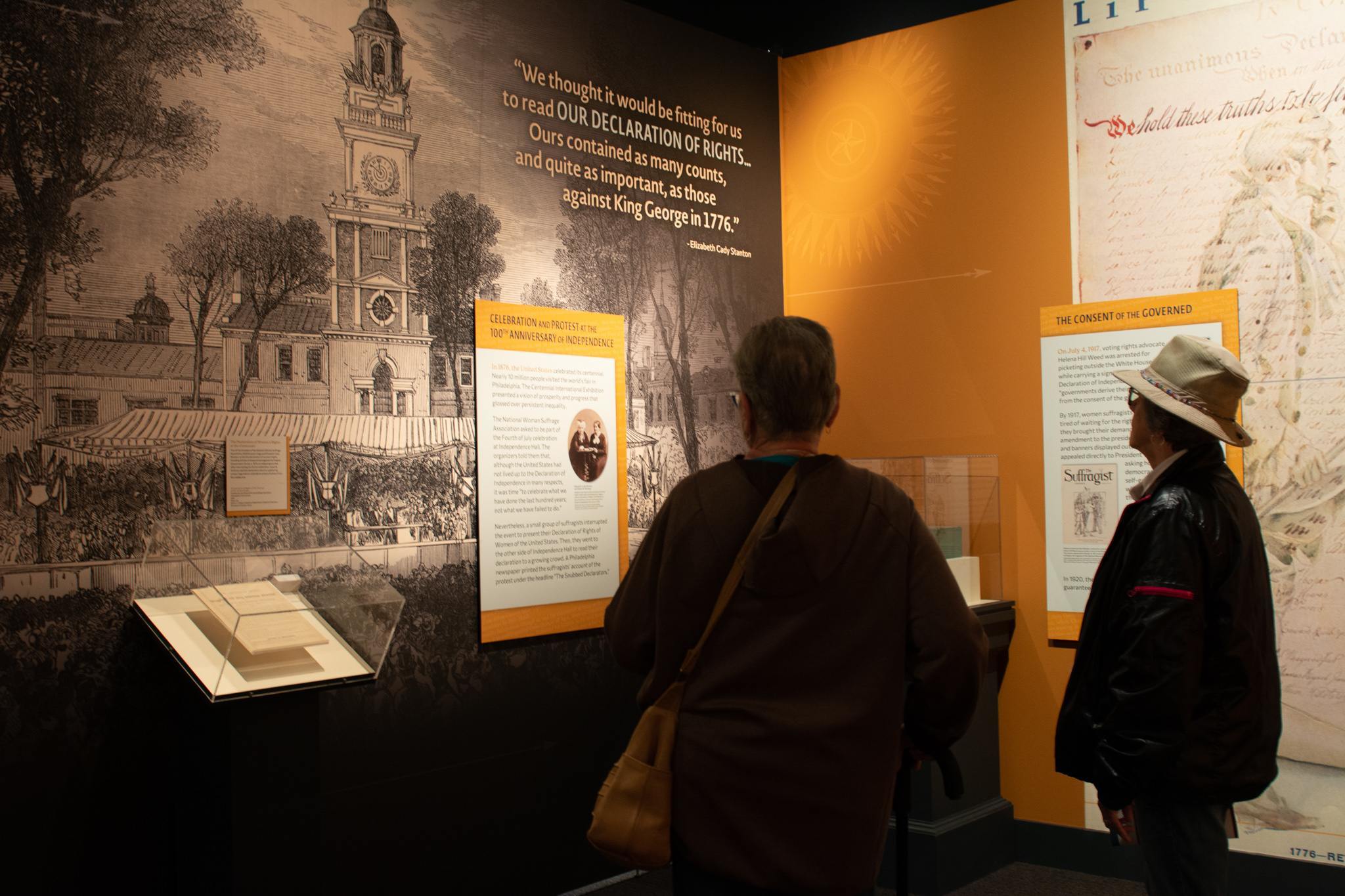 Two people look at information in "The Declaration's Journey"