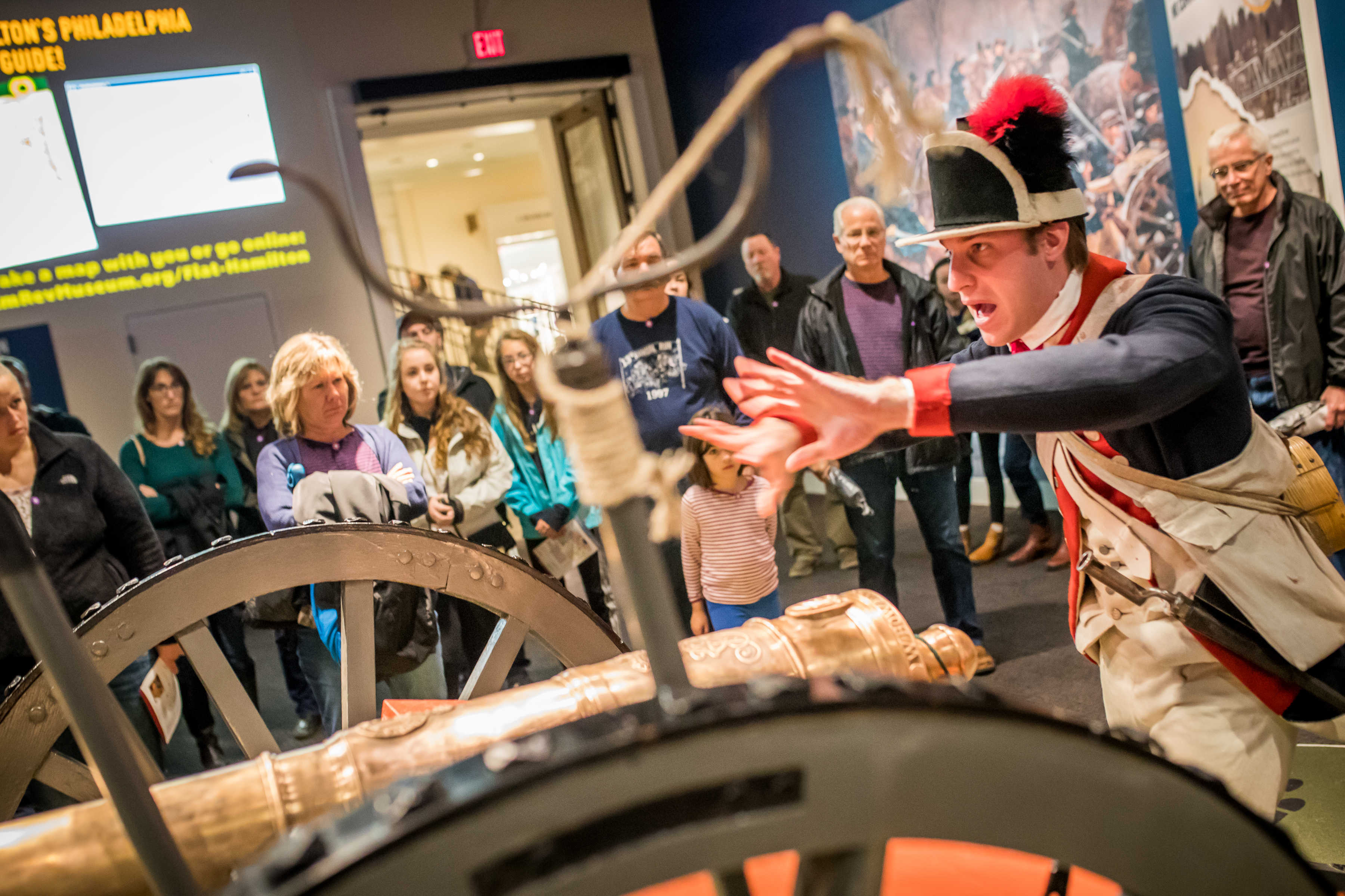 A male costumed Museum educator gives a demonstration about a cannon as part of the Hamilton Was Here exhibit.