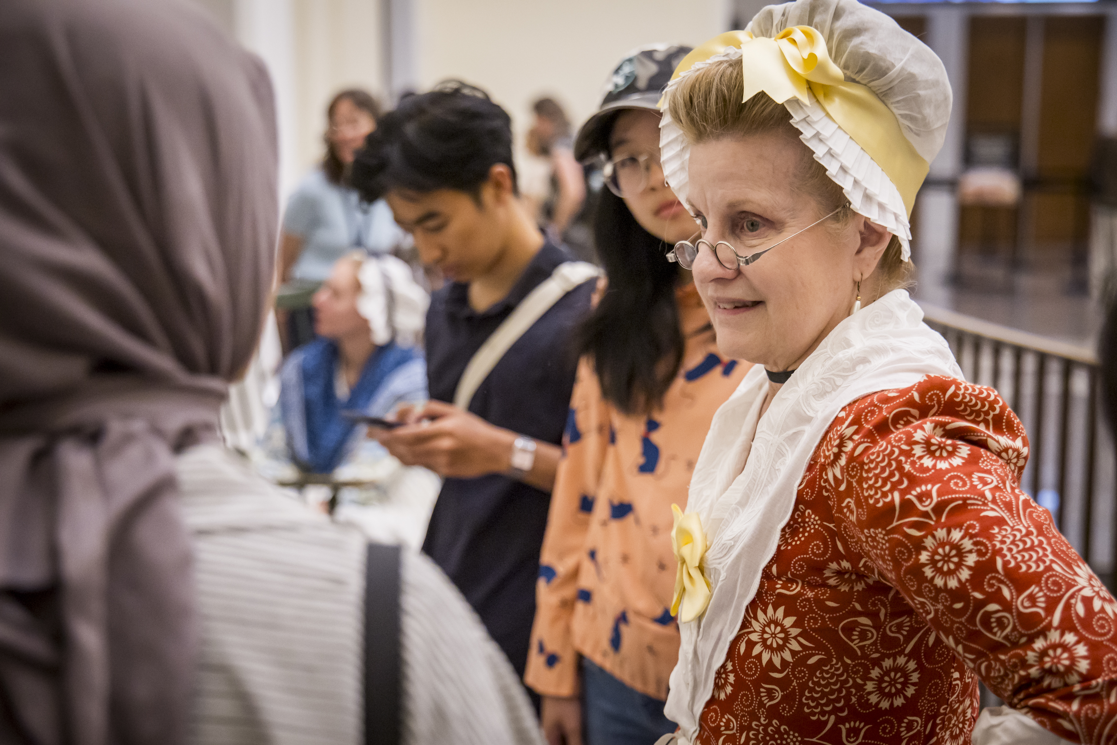 A costumed interpreter talks with guests