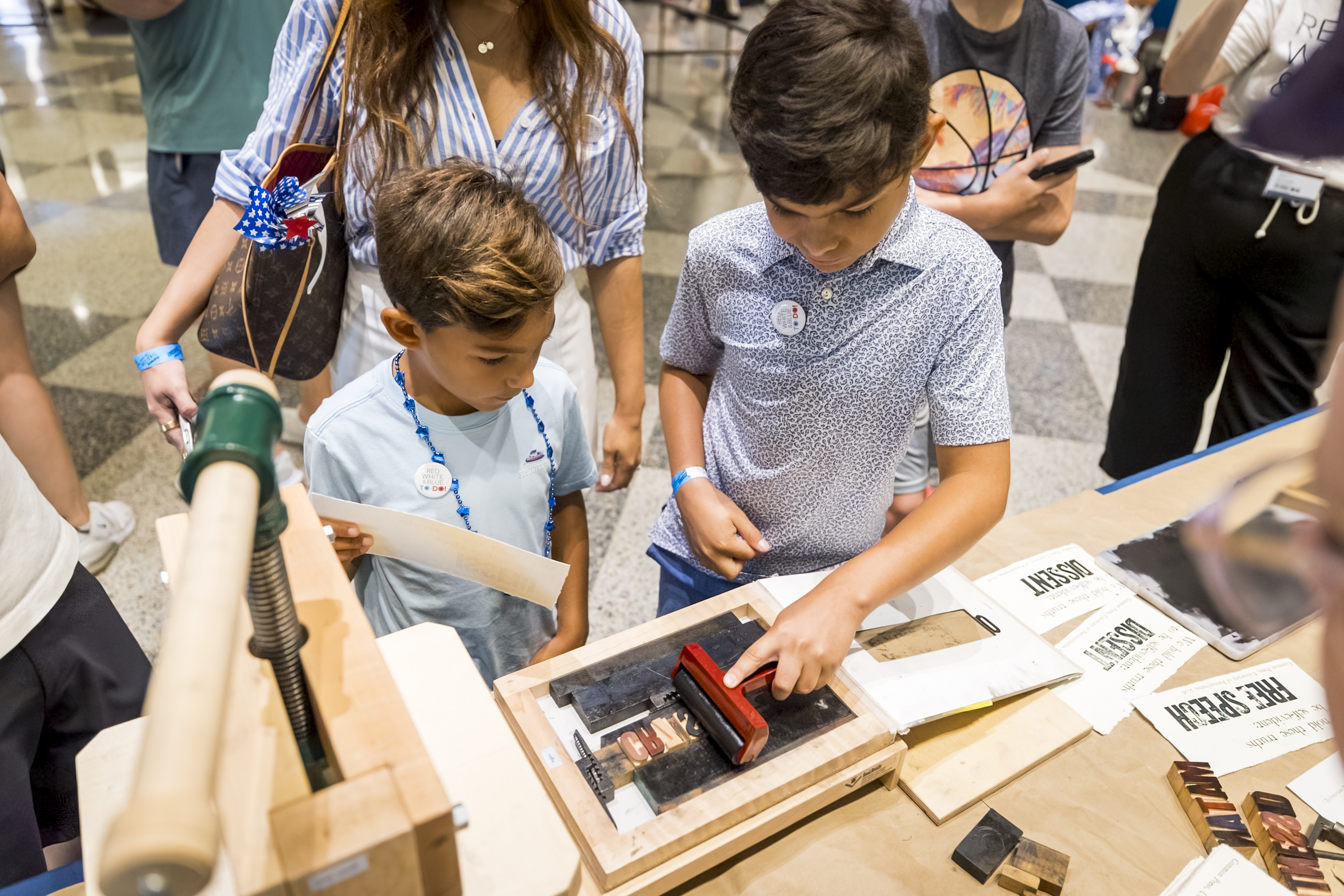 Two children make a printing craft
