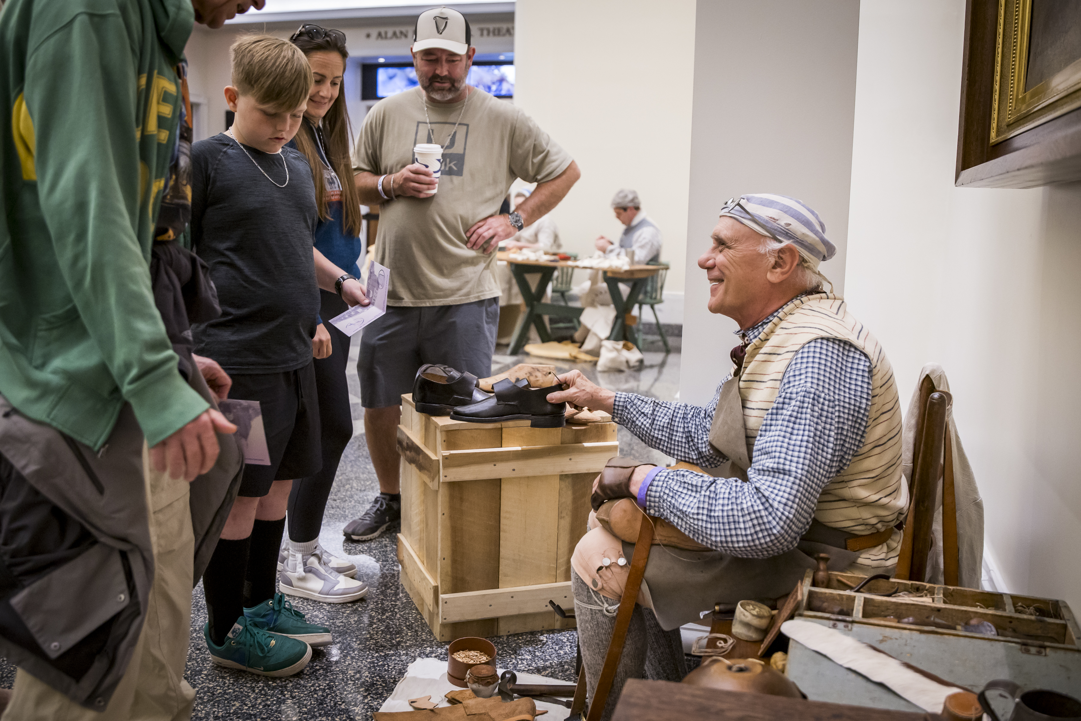 A costumed interpreter interacts with guests
