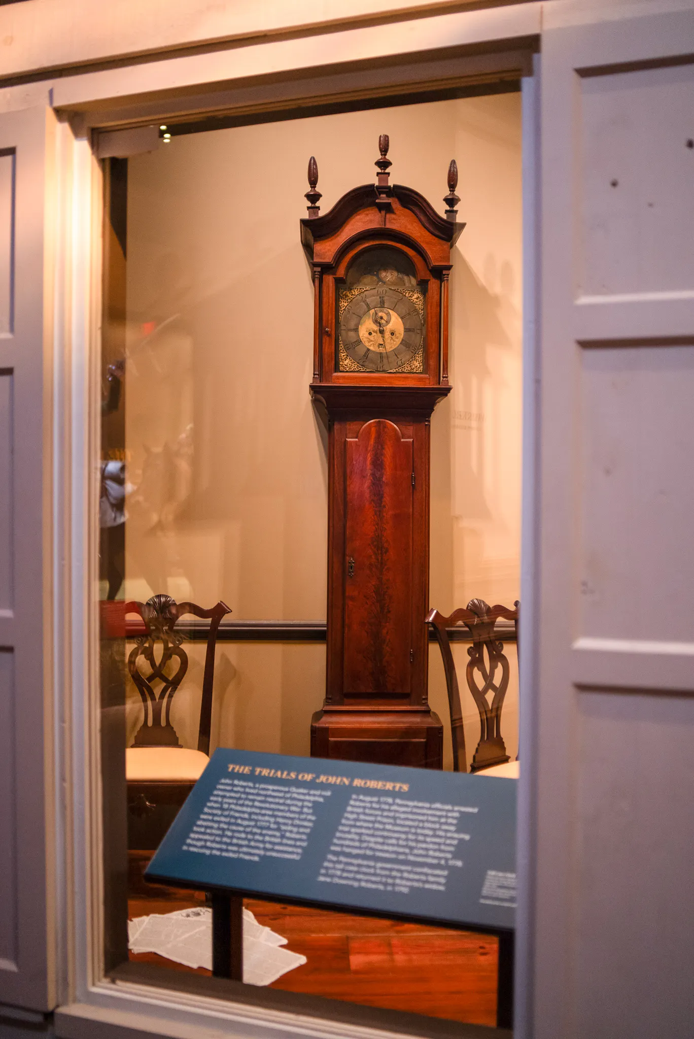 A wooden clock with an intricately designed face