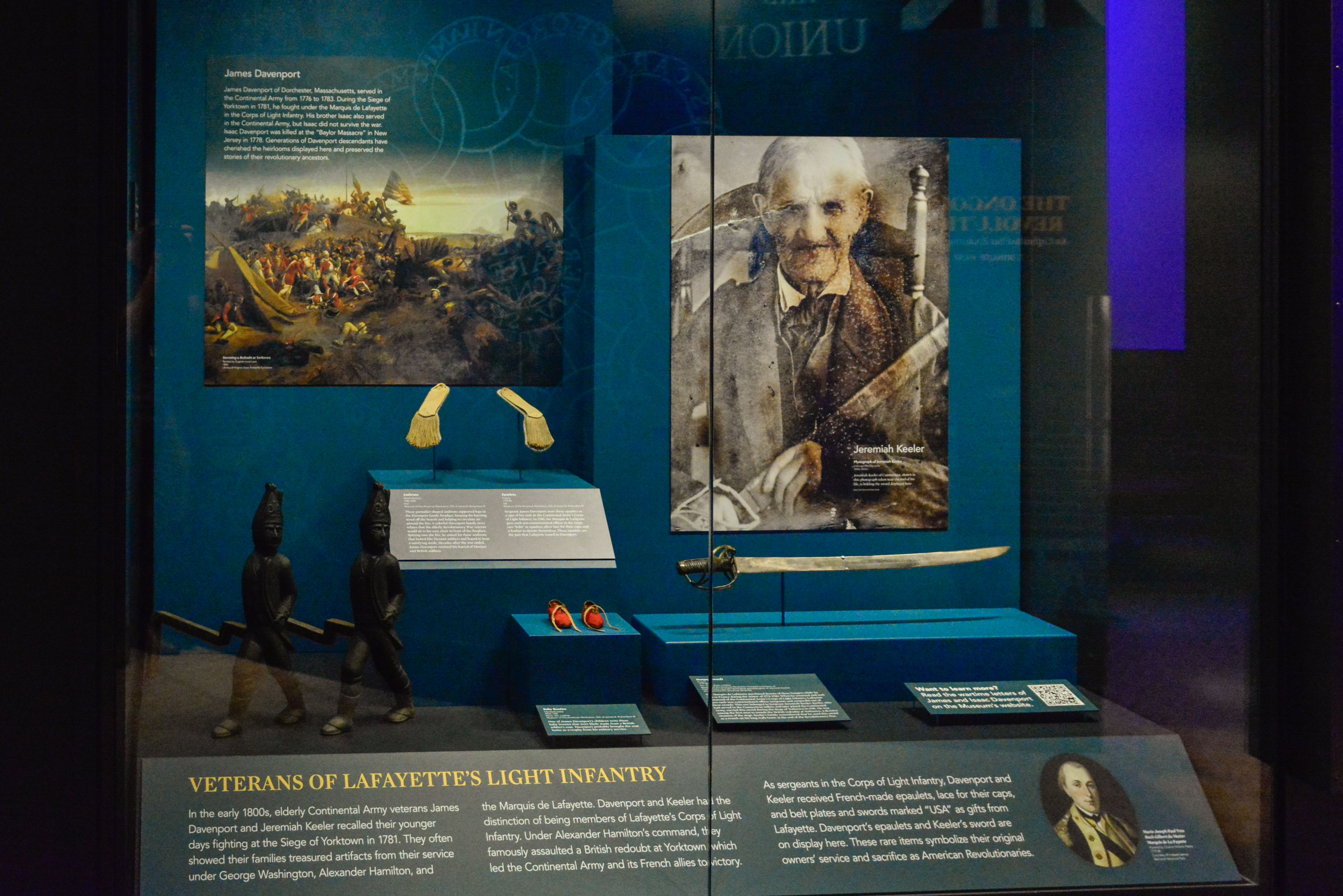 This image shows a display in the museum with artifacts related to Continental Army soldiers James Davenport and Jeremiah Keeler who both served under the Marquis de Lafayette.