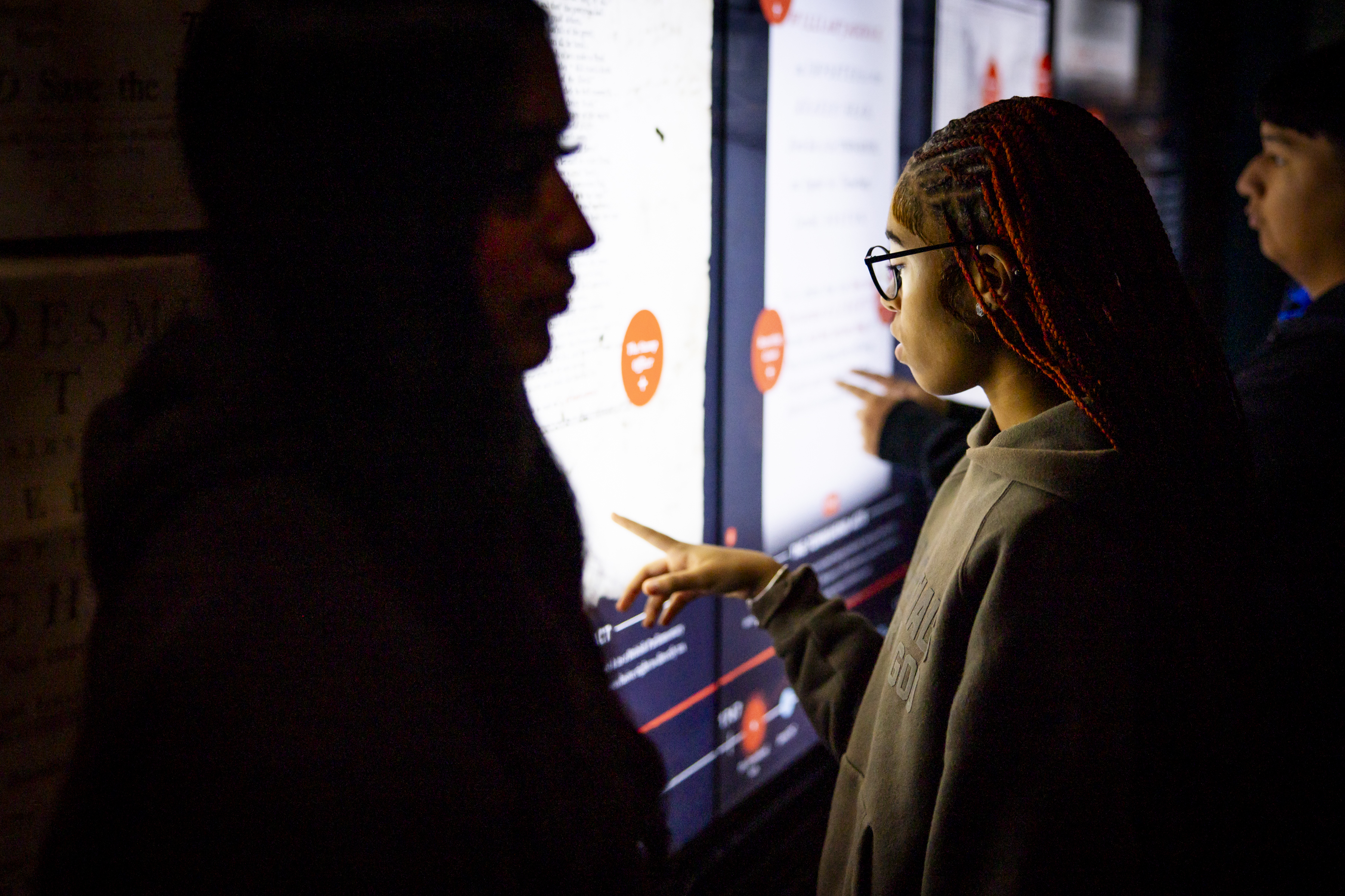 A student uses the Posters of Protest touchscreen interactive in the Museum's core exhibition.