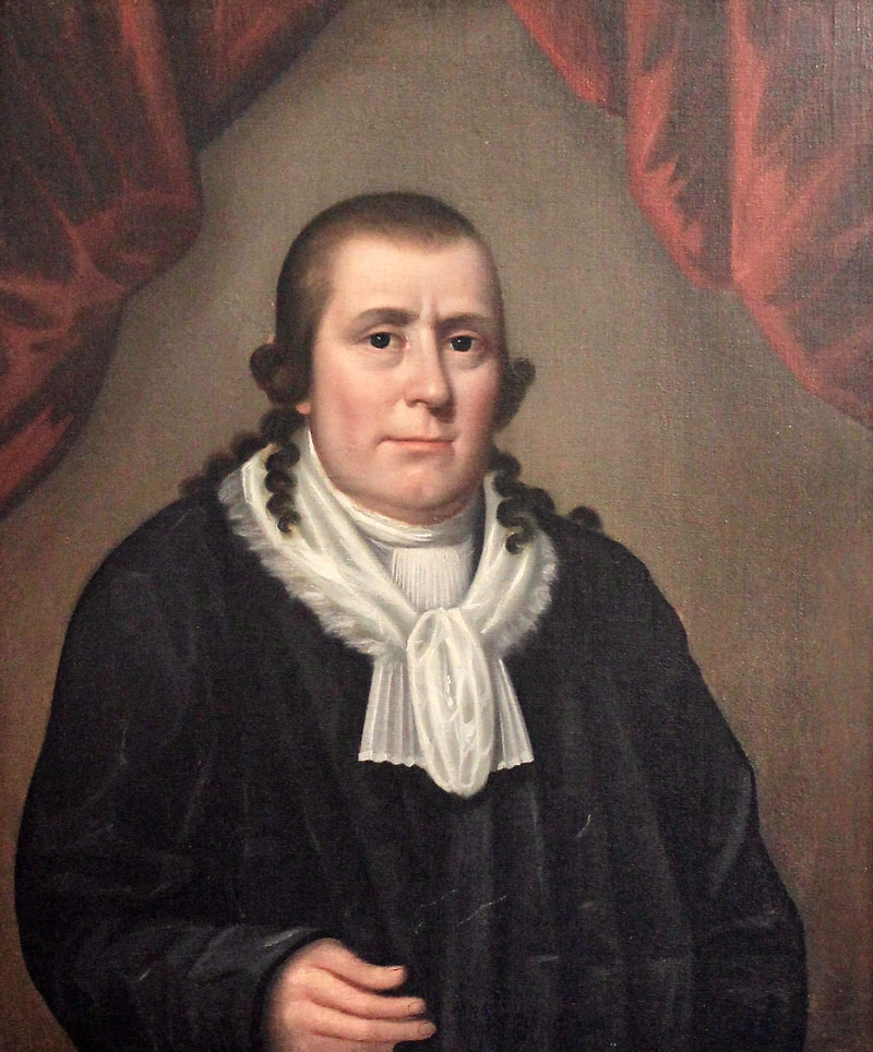 A portrait of the Public Universal Friend. They have dark hair with long, curled sides, and are dressed in black with a white collar.